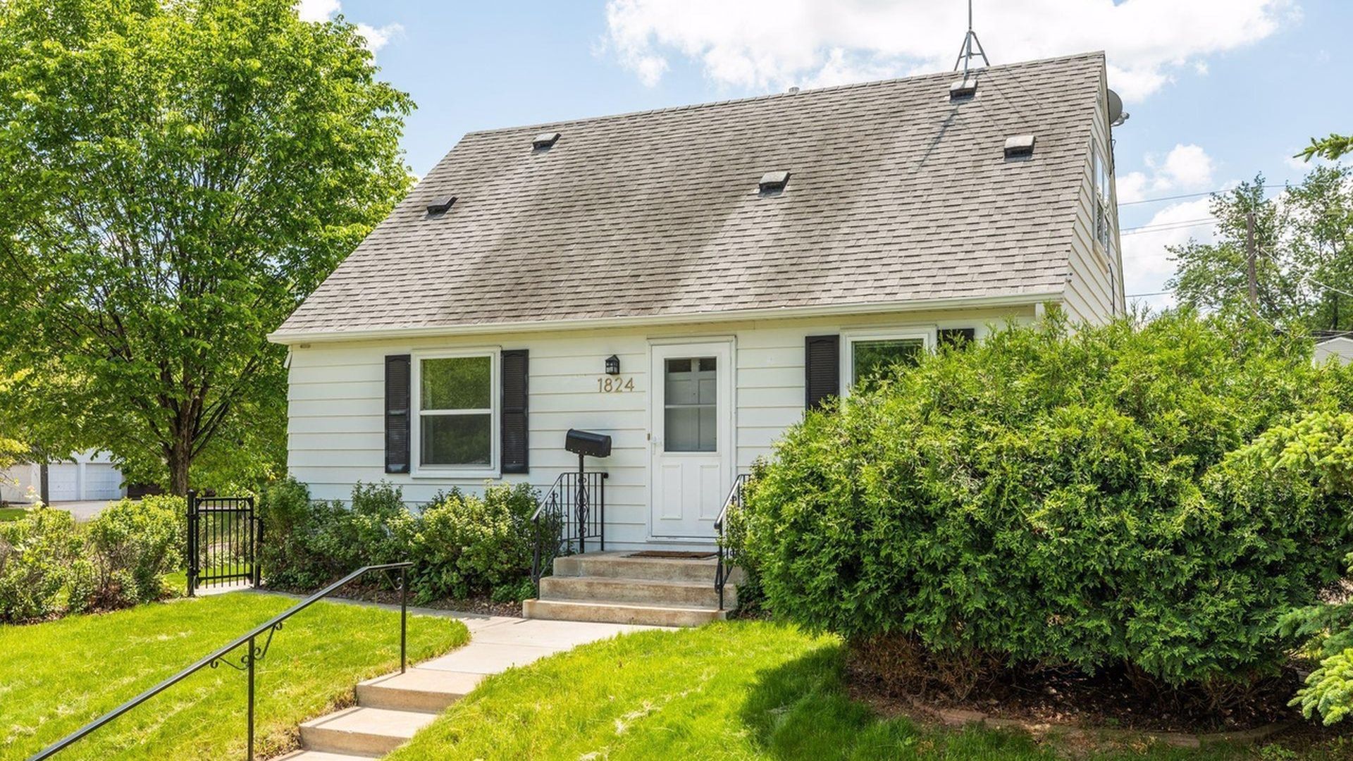 exterior view of home with greenery around it