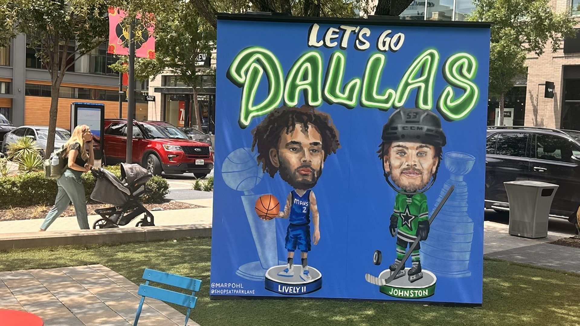 A mural saying Dallas, with cartoon-like images of a basketball and ice hockey player