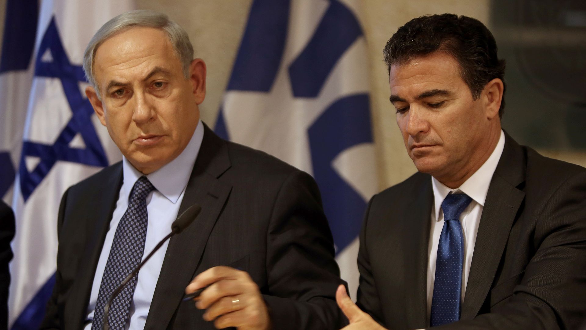 Prime Minister Benjamin Netanyahu sitting next to Yossi Cohen