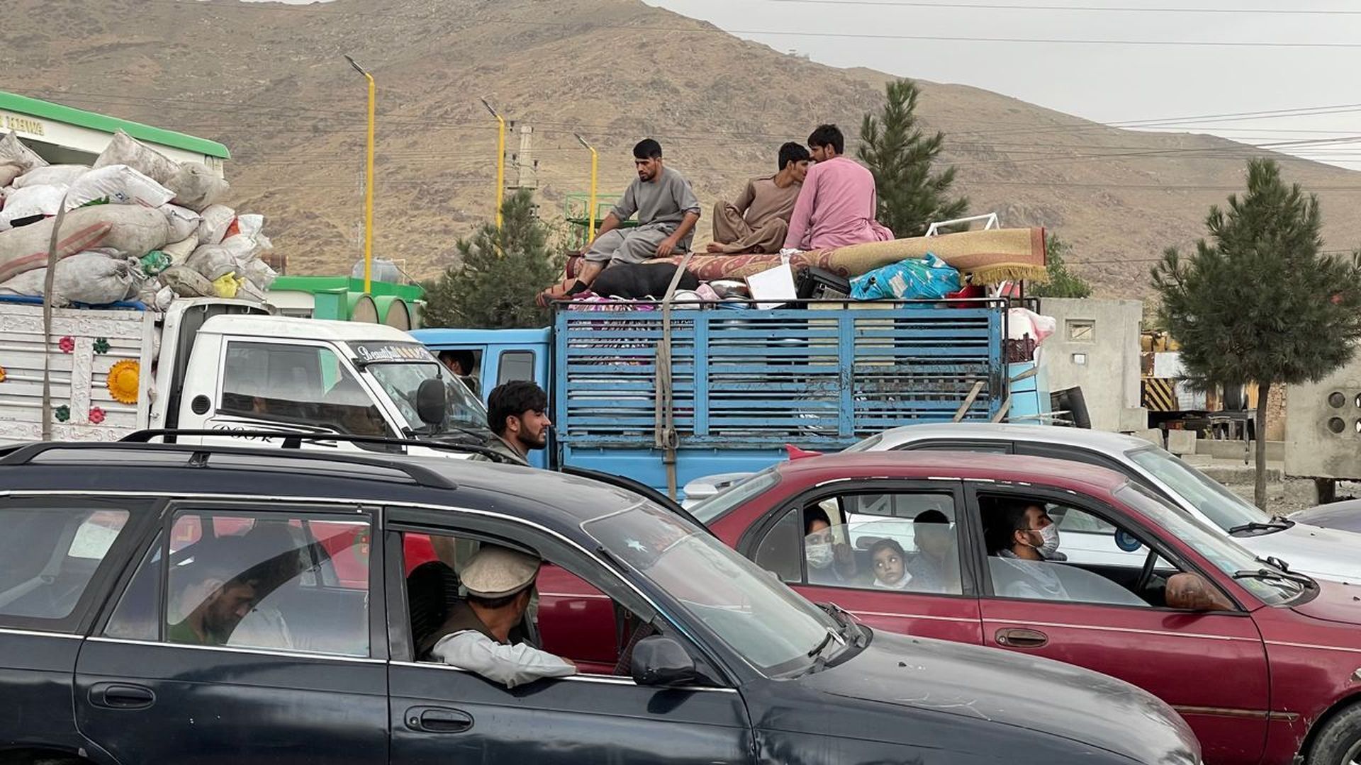 Afghans continue to wait around the Hamid Karzai International Airport as they try to leave the Afghan capital of Kabul, Afghanistan on August 21.