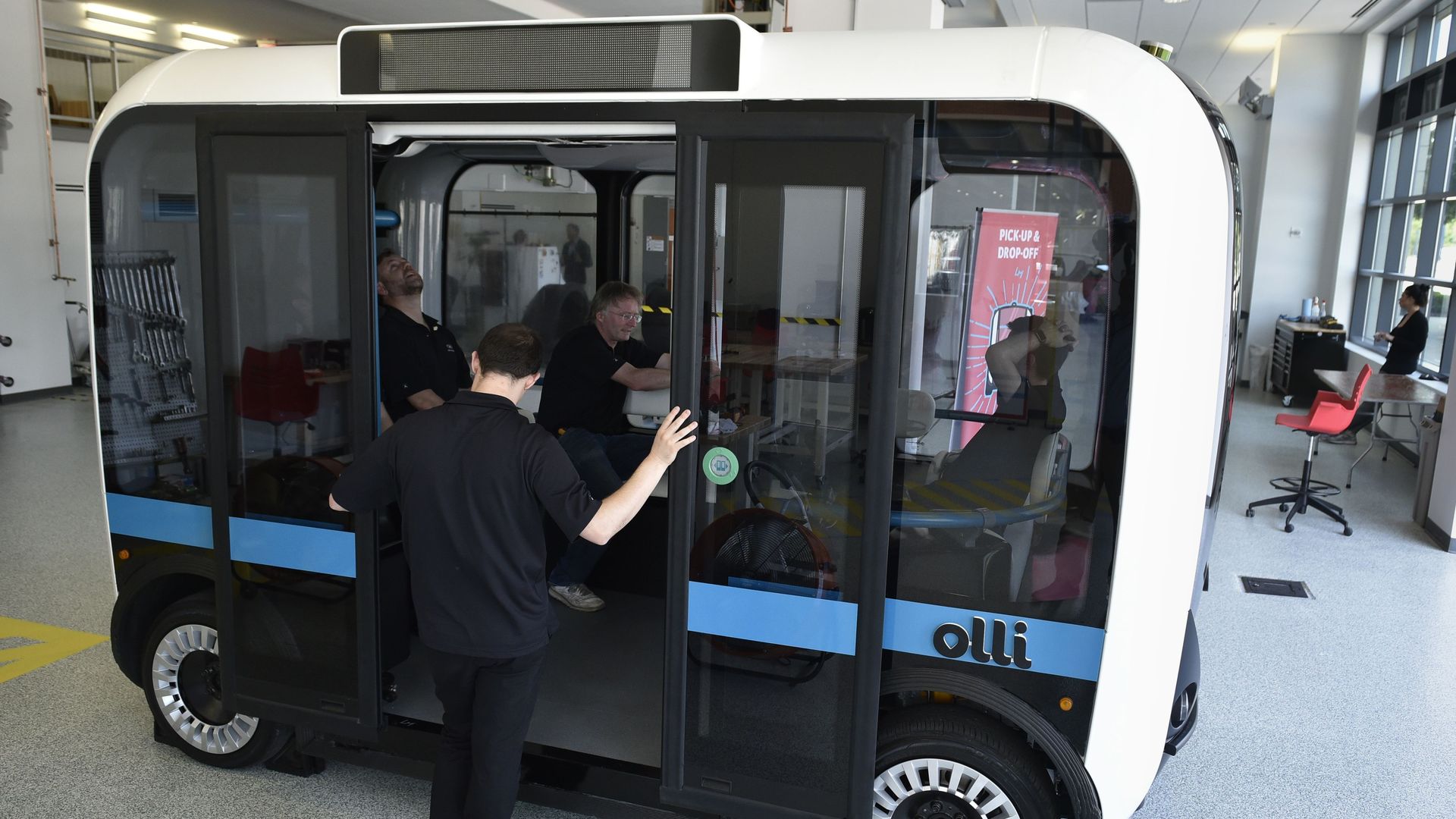 A man entering an Olli autonomous shuttle