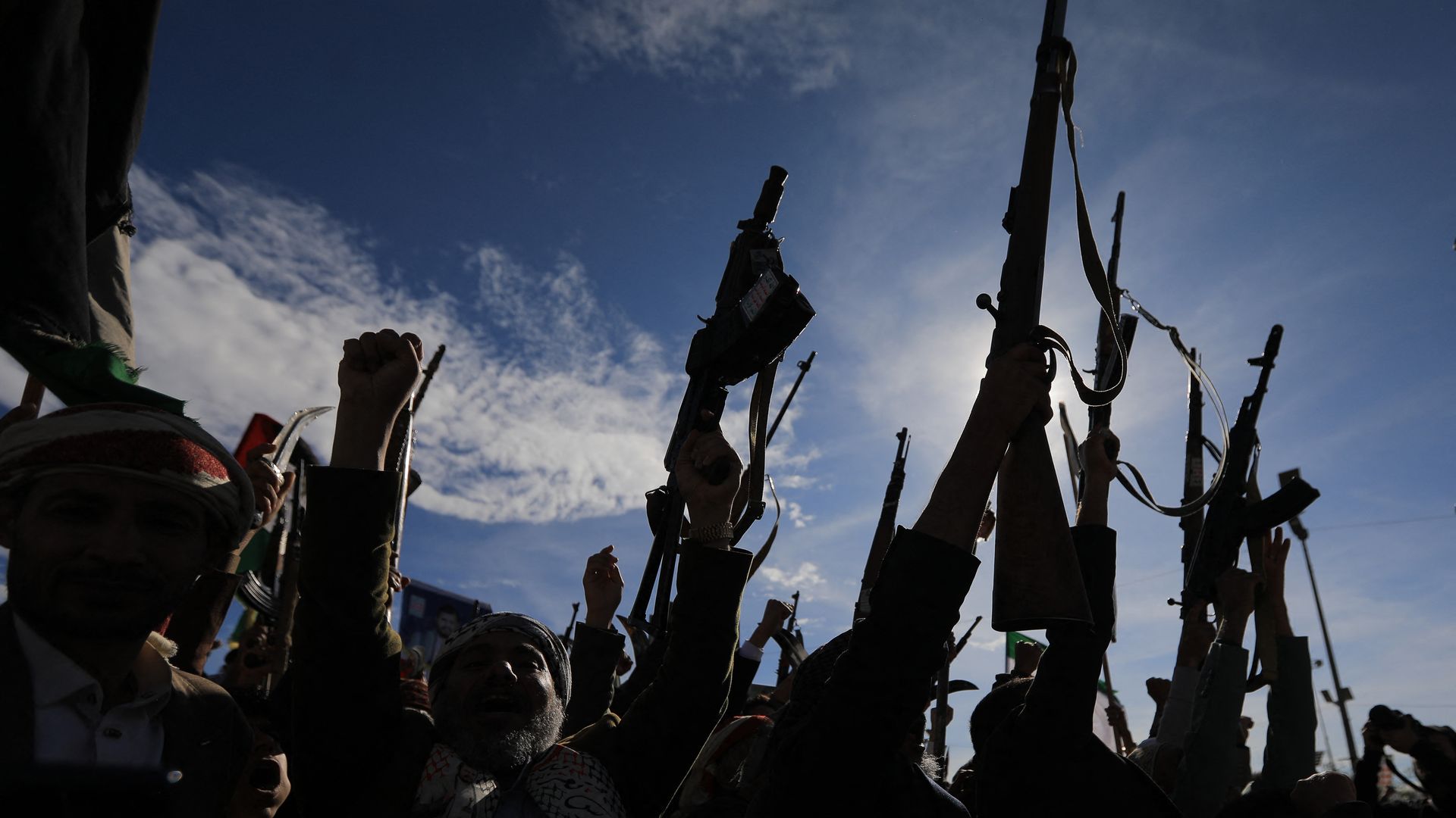 Armed Houthi supporters gather in Yemen’s capital, Sanaa, holding rifles during a large rally.