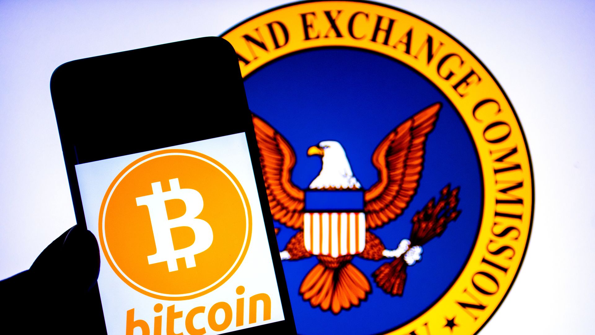 INDIA - 2024/09/26: In this photo illustration, a Bitcoin logo seen displayed on a smartphone with a U.S. Securities and Exchange Commission logo in the background.