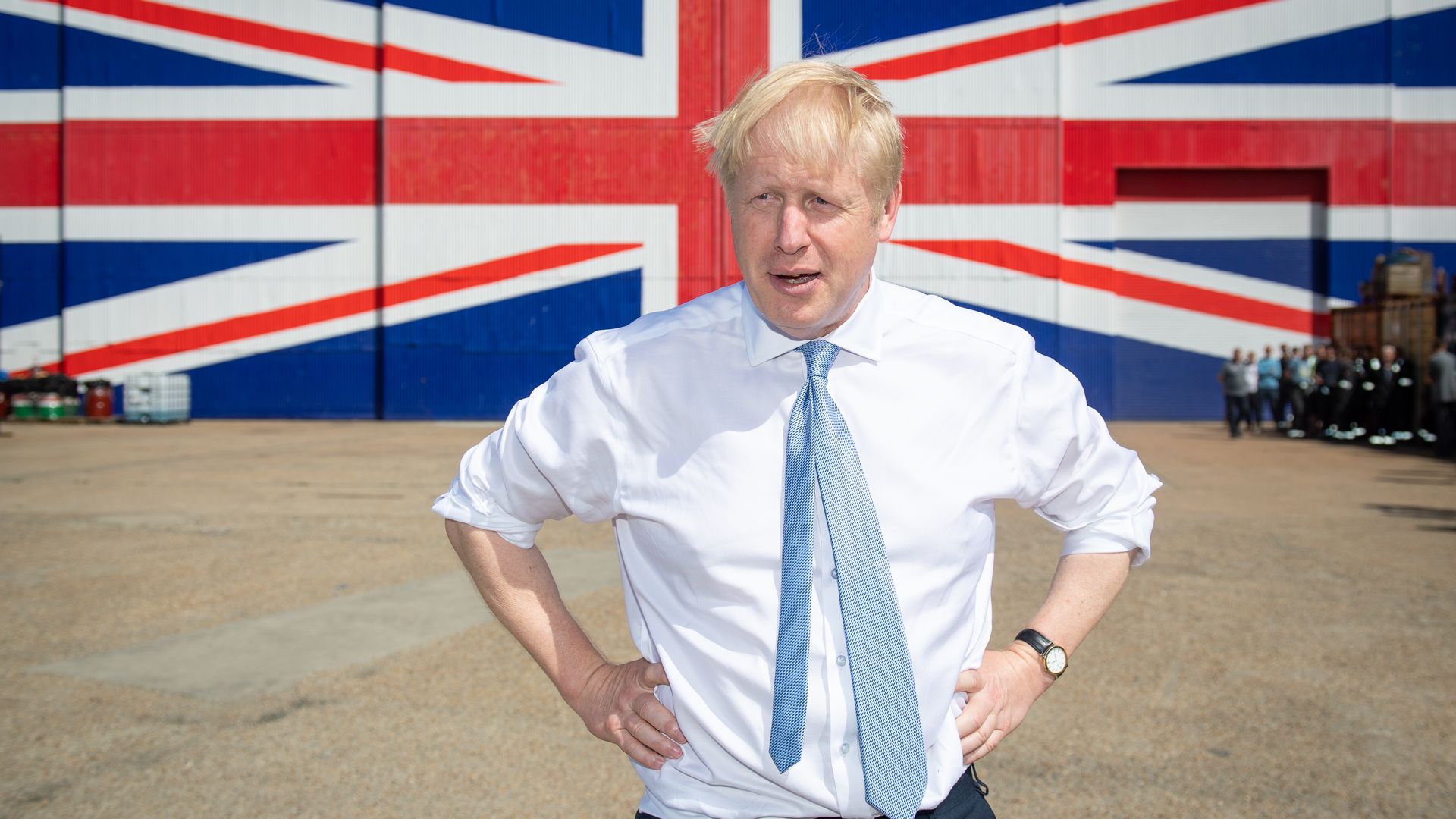 Then-Conservative party leadership contender Boris Johnson  in front of a Union Jack on a wall at the Wight Shipyard Company at Venture Quay during a visit to the Isle of Wight on June 27