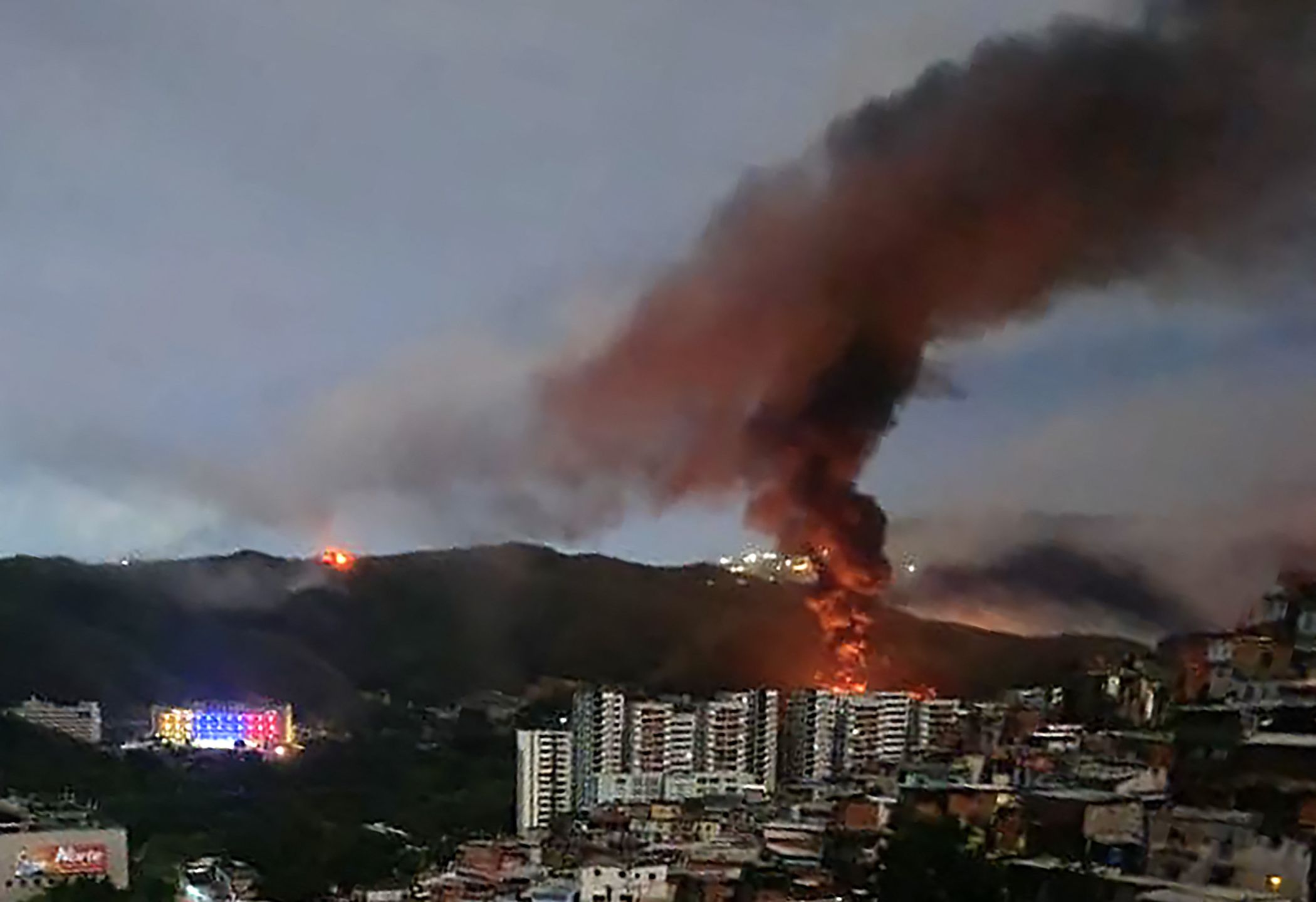 ire at Fuerte Tiuna, Venezuela's largest military complex, is seen from a distance after a series of explosions in Caracas on January 3, 2026. The United States military was behind a series of strikes against the Venezuelan capital Caracas on Saturday, US media reported. The White House and Pentagon