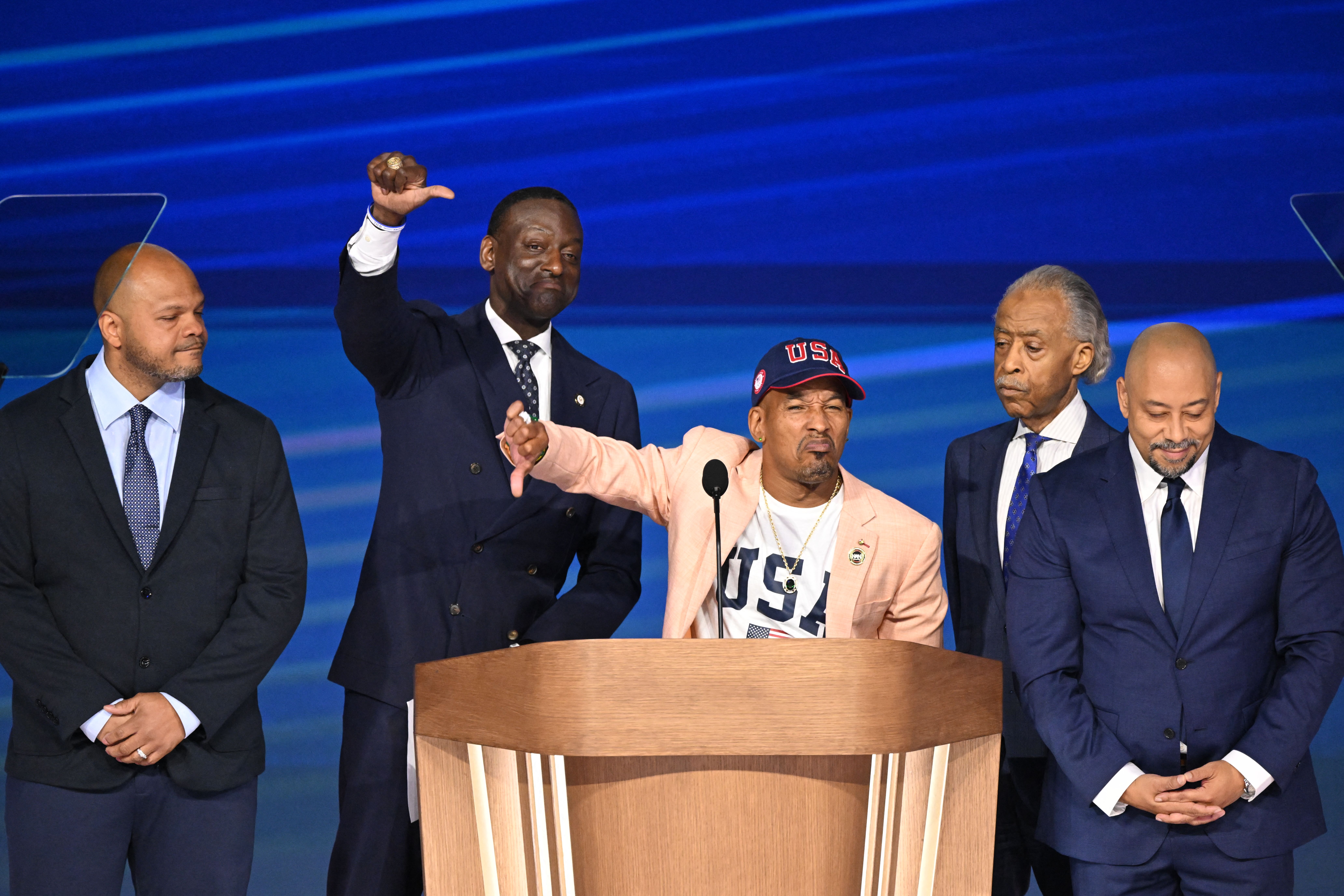 Rev. Al Sharpton (4R) is joined onstage by members of the "Central Park Five," L-R, Kevin Richardson, Yusef Salaam, Korey Wise, and Raymond Santana on the fourth and last day of the Democratic National Convention (DNC) at the United Center in Chicago, Illinois, on August 22, 2024.