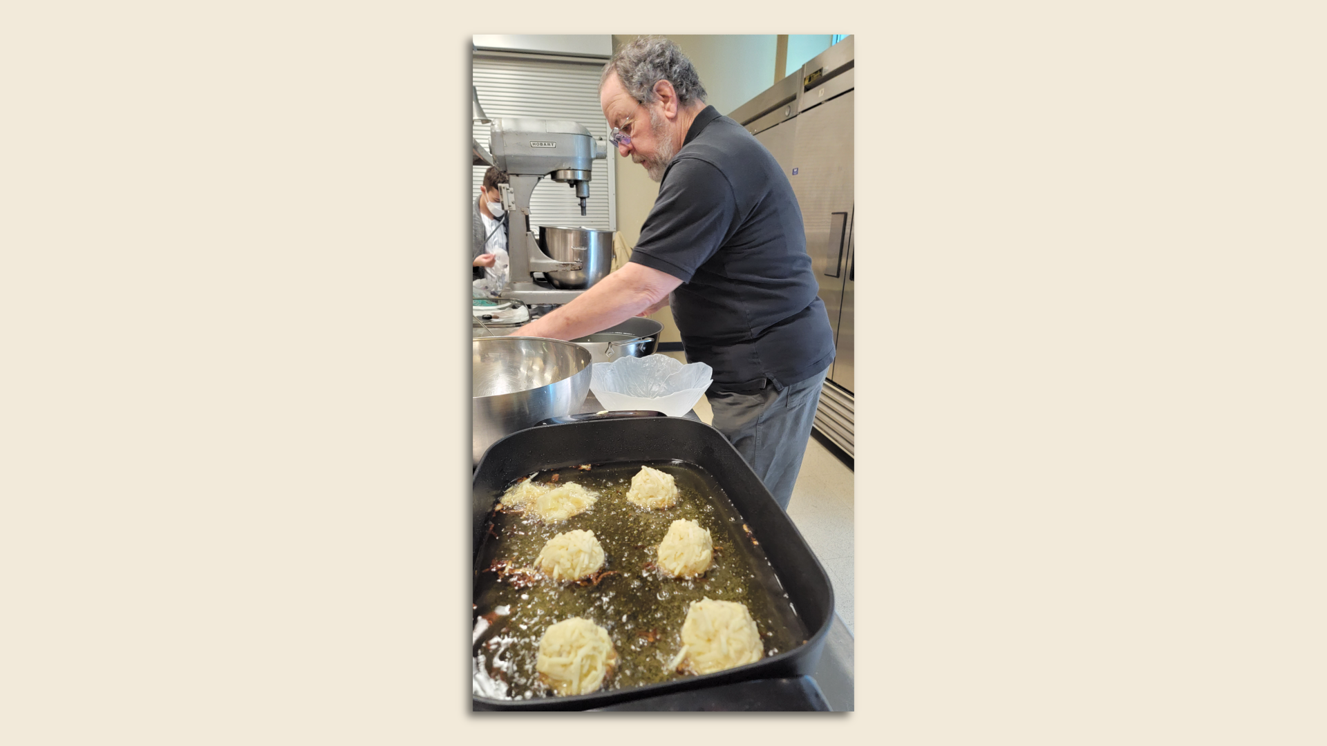 Marvin Hecker presiding over latke-making