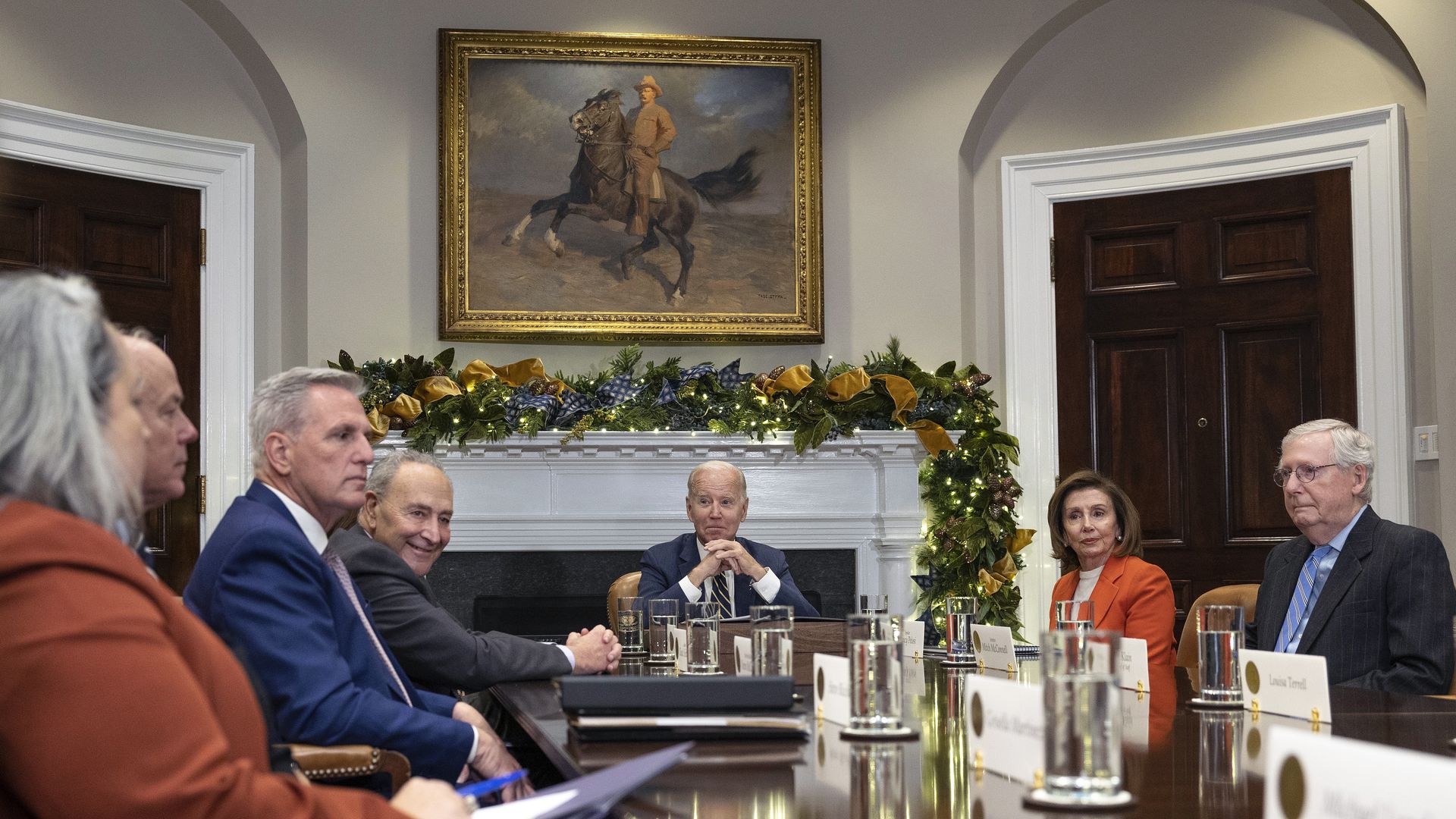 McCarthy and Biden around a table with other congressional leaders and a painting of Teddy Roosevelt presiding