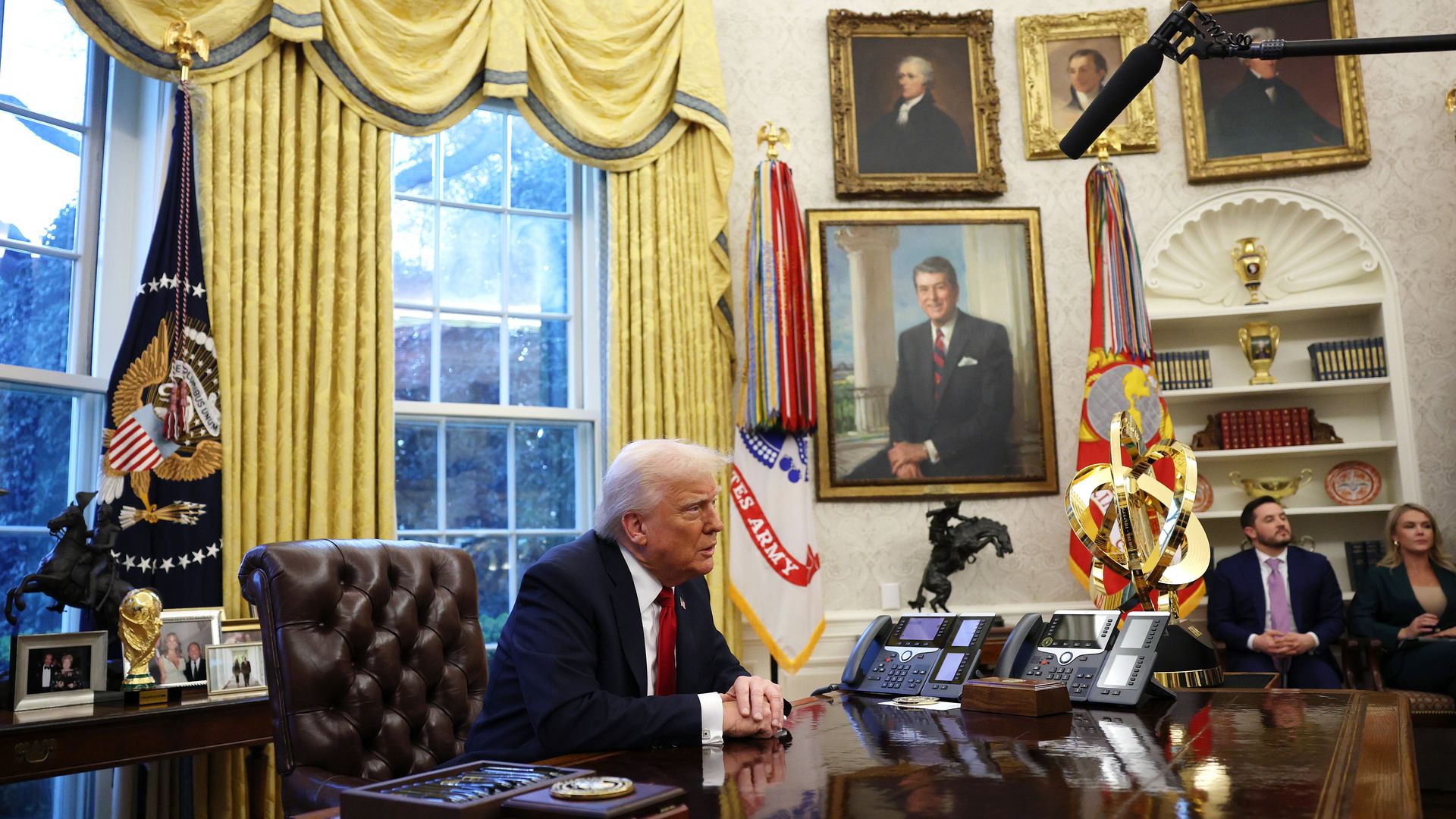 Trump sits in the Oval Office