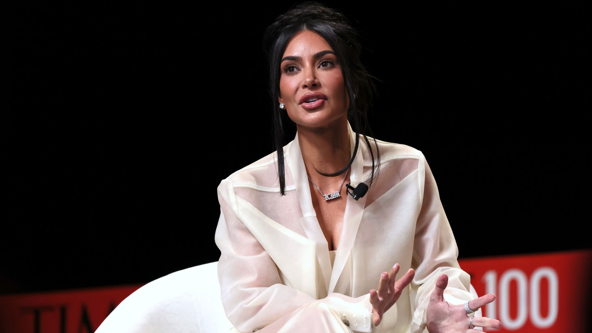 Media personality and entrepreneur Kim Kardashian speaks on stage at an event.