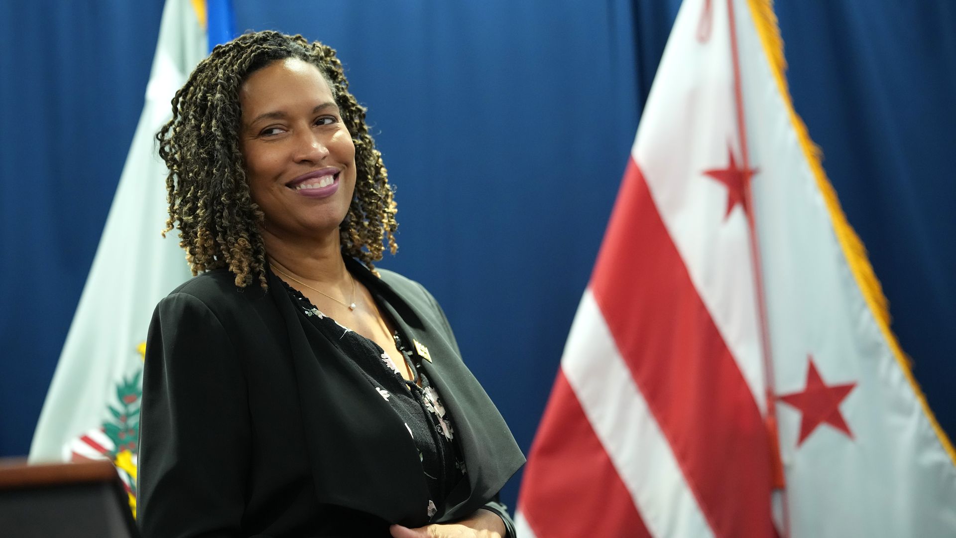 Muriel Bowser is photographed in front of a D.C. flag