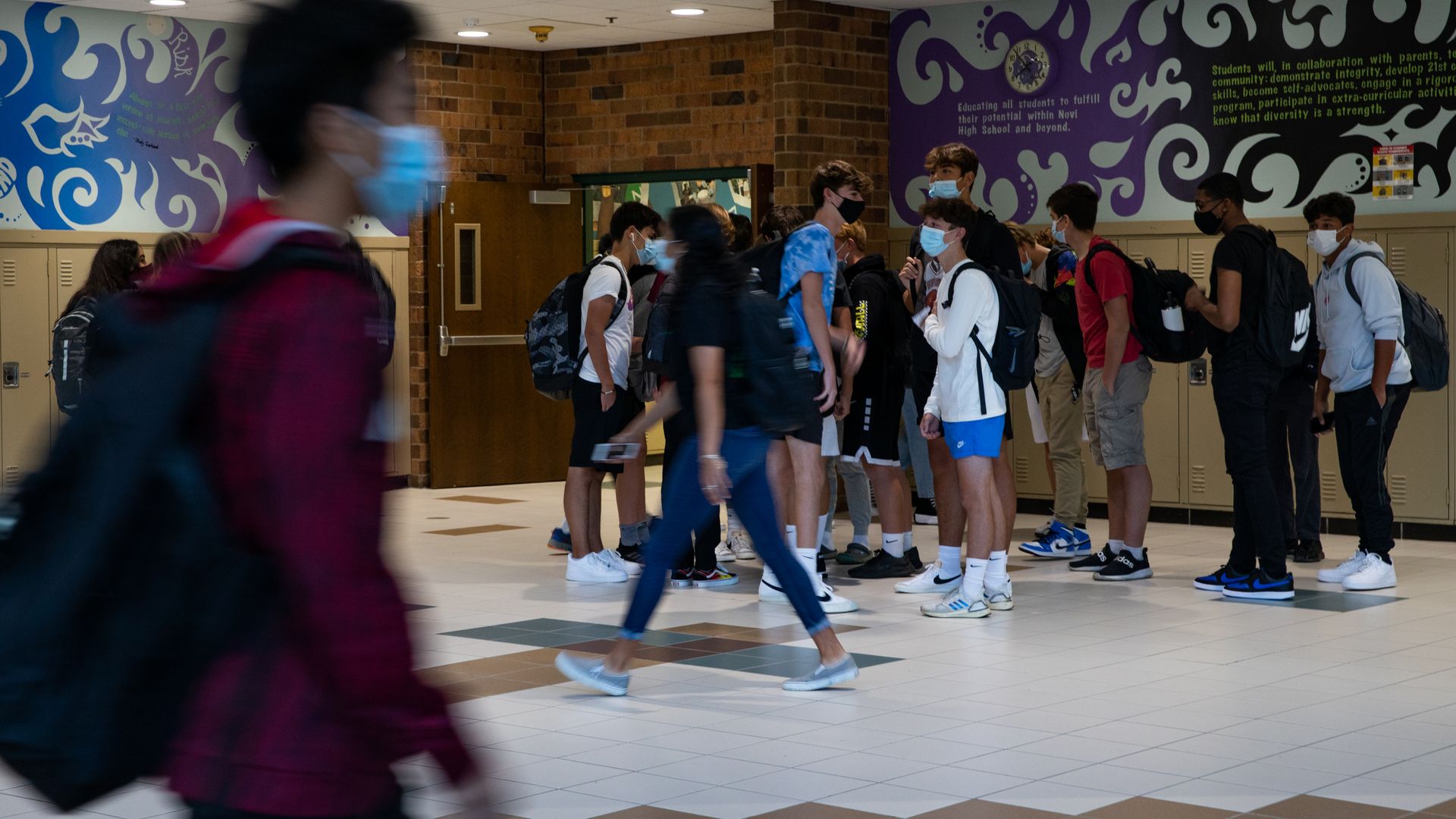 Students walk through the hallway at a high school during the first day of classes in Novi, Michigan, U.S., on Tuesday, Sept. 7 2021.