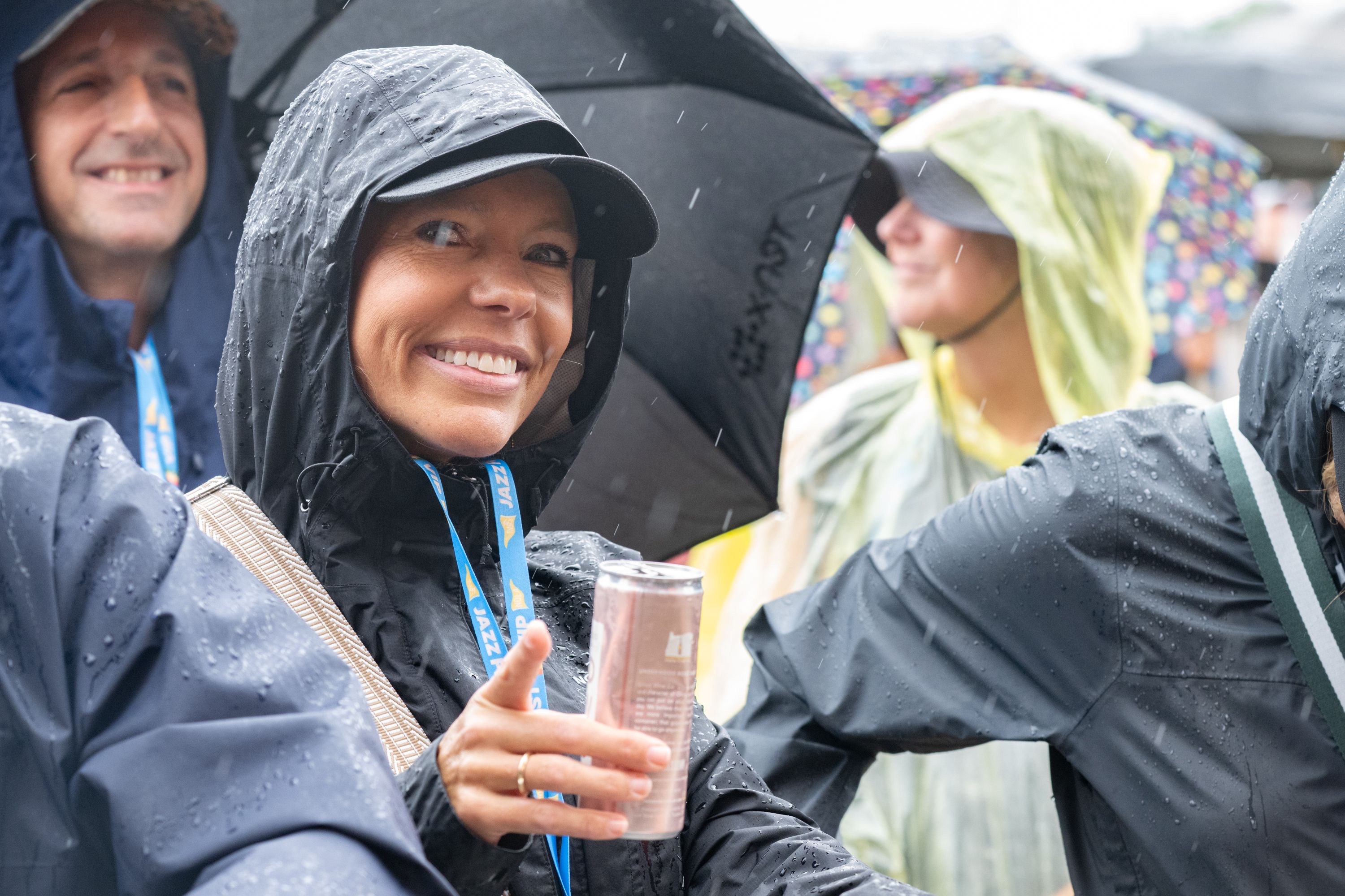 Photo shows smiling people in ponchos