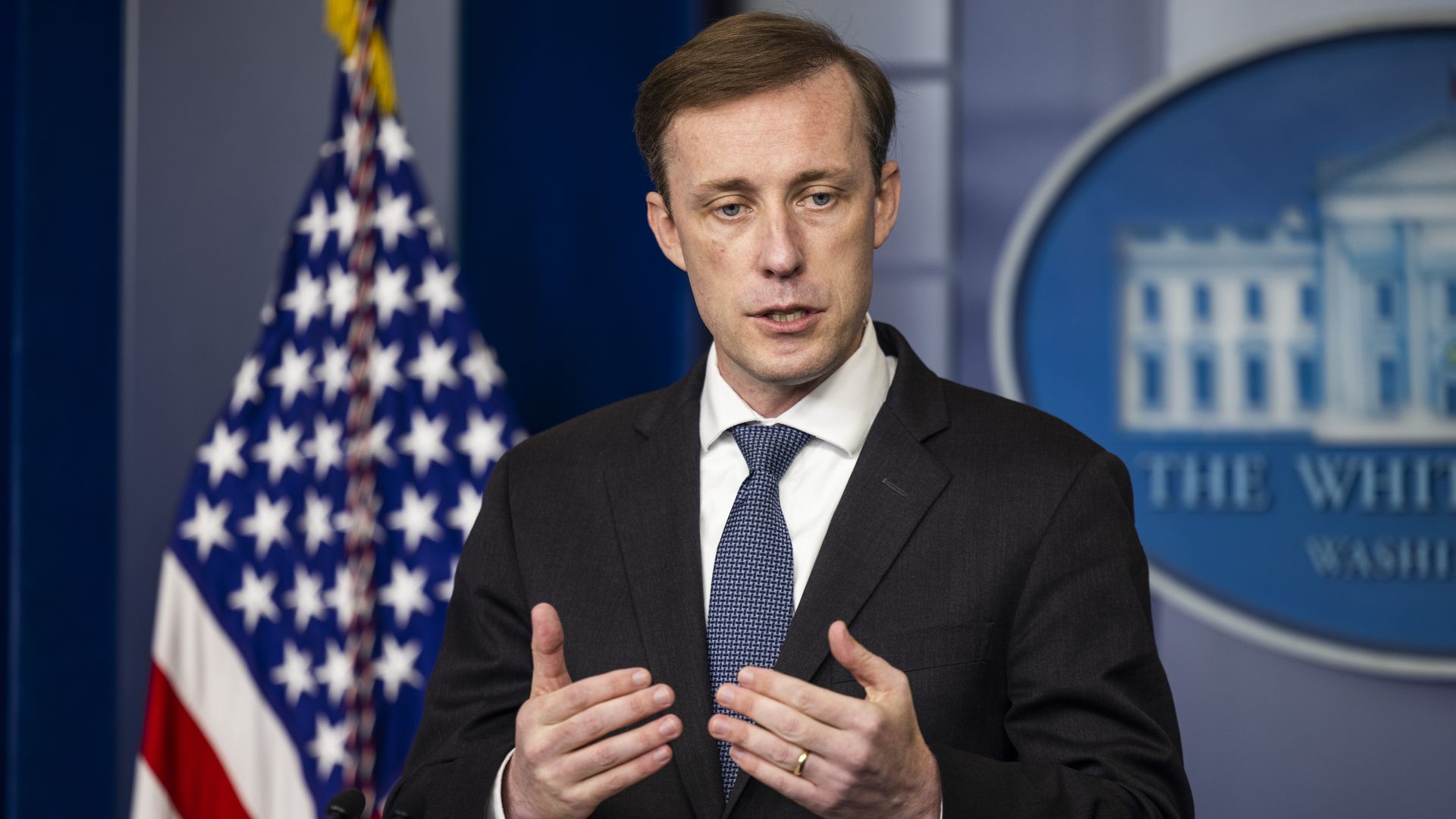 National security adviser Jake Sullivan is seen addressing reporters at the White House.