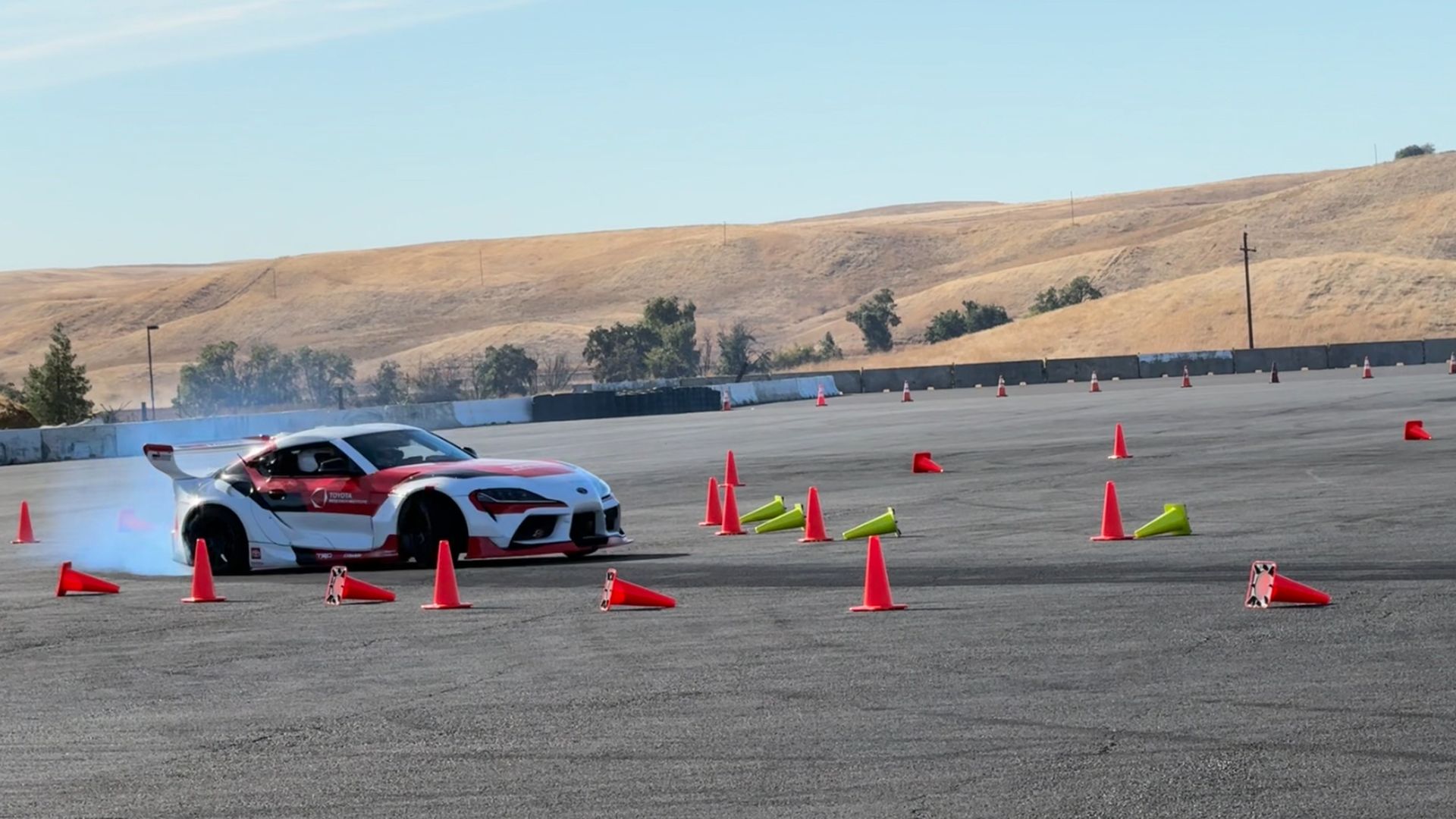 A Toyota self-driving test car navigates cones at a race track in Willows, Calif.