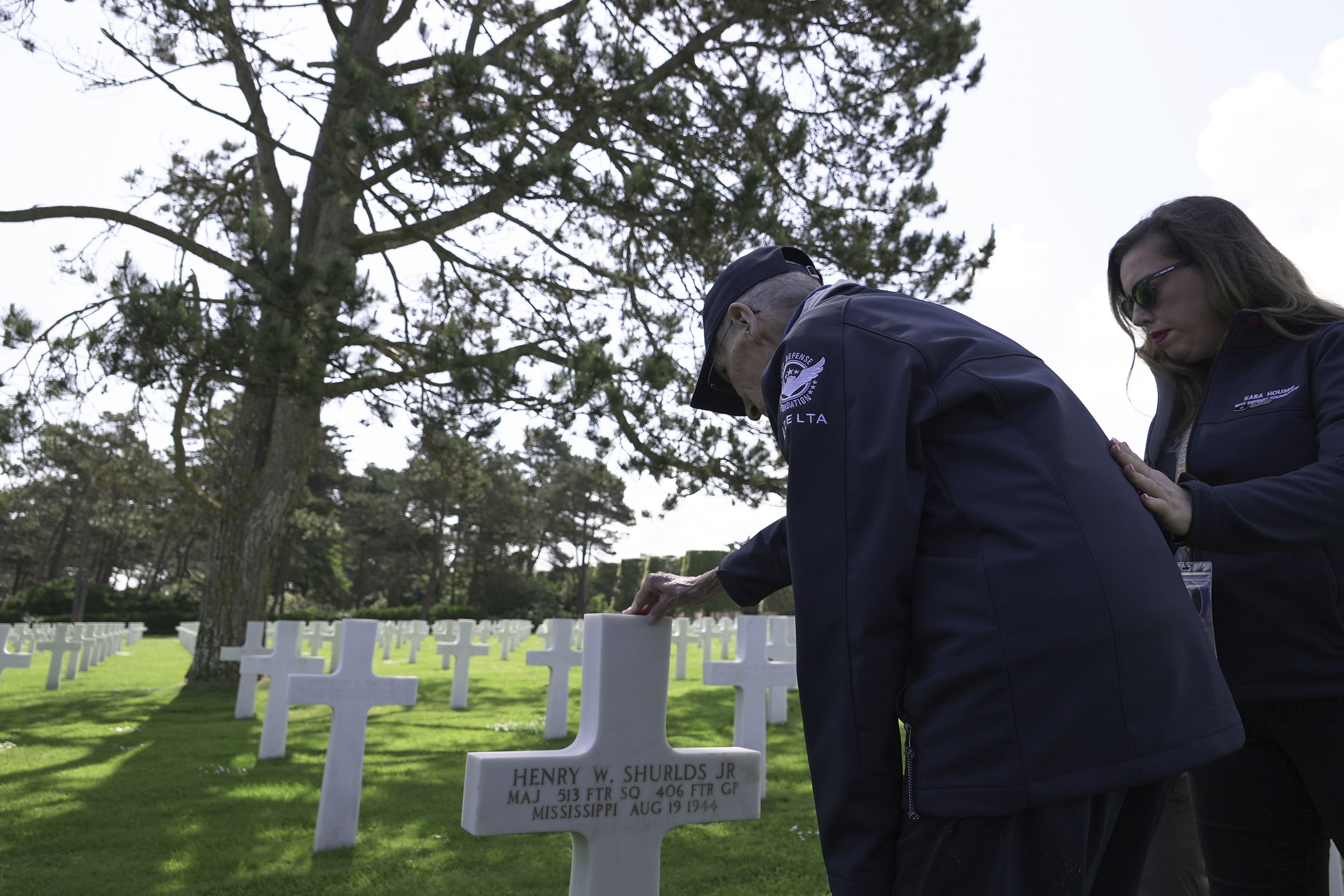 Wally King, a 101-year-old former U.S. fighter pilot who flew 75 combat missions in World War II, and his granddaughter pay their respects at the Normandy American Cemetery in Colleville-sur-Mer, France.
