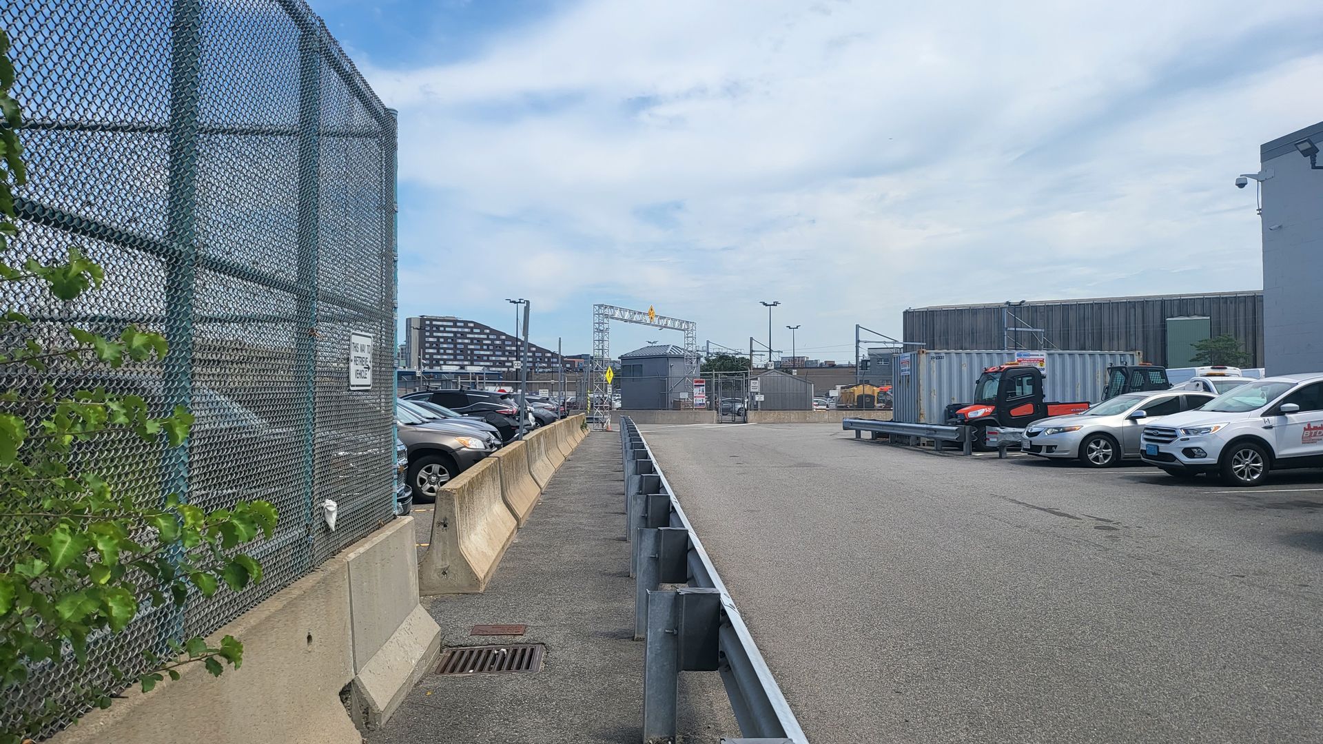 A long alleyway in a parking lot.