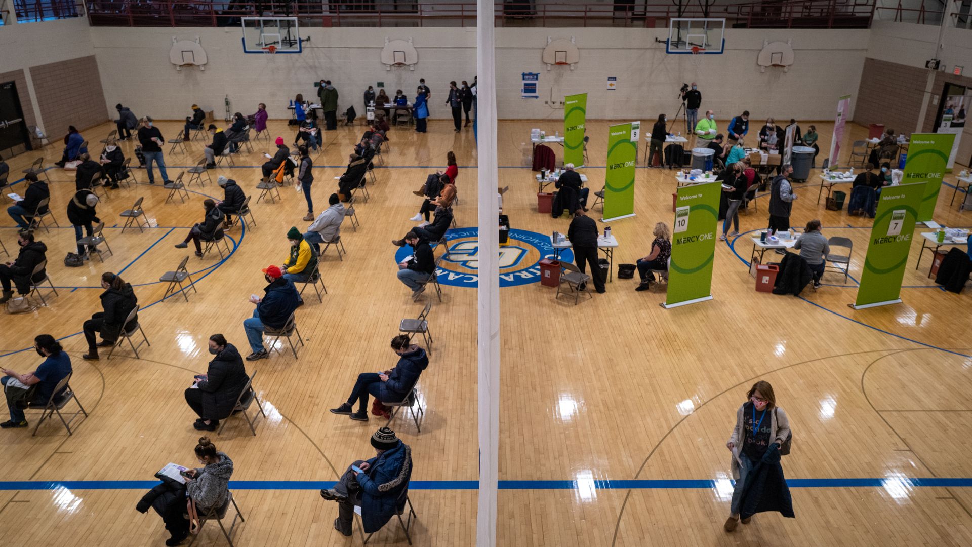 DMPS staff wait to receive their first dose of the Pfizer COVID-19 vaccine.