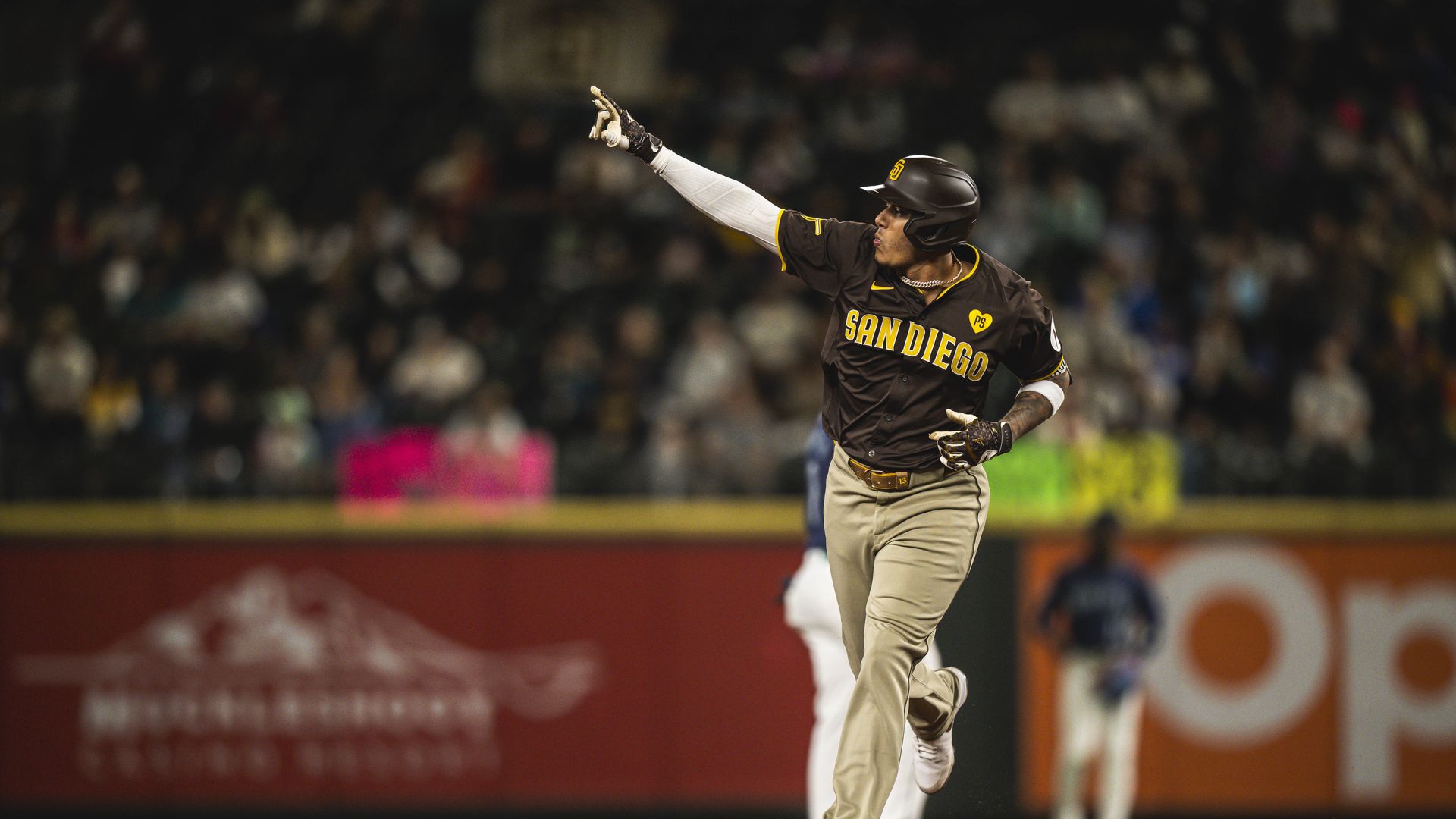 Machado points to the crowd while rounding the bases after a home run