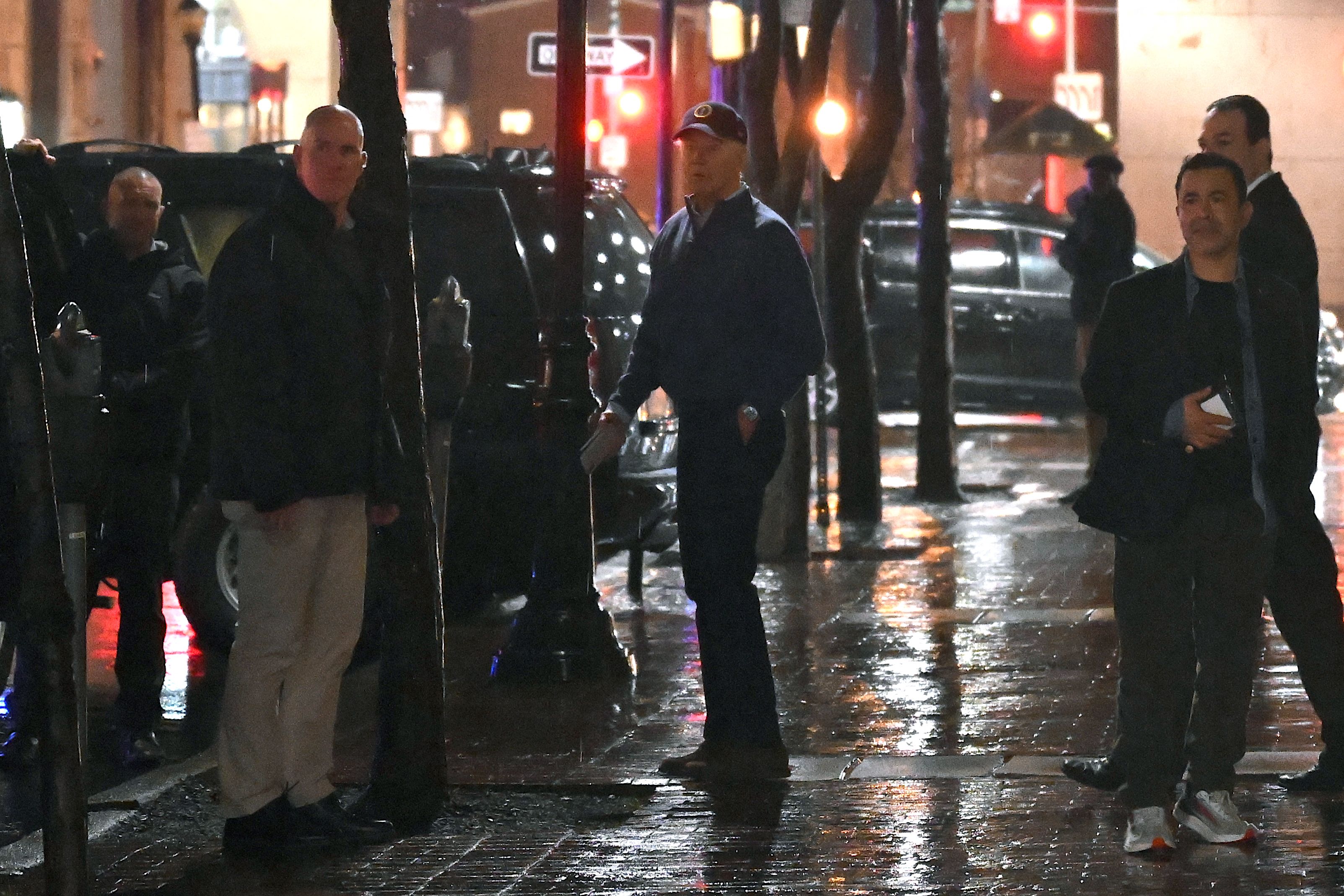 US President Joe Biden (C) looks on after a car hit an SUV in the motorcade as he left his campaign headquarters in Wilmington, Delaware on December 17, 2023. 