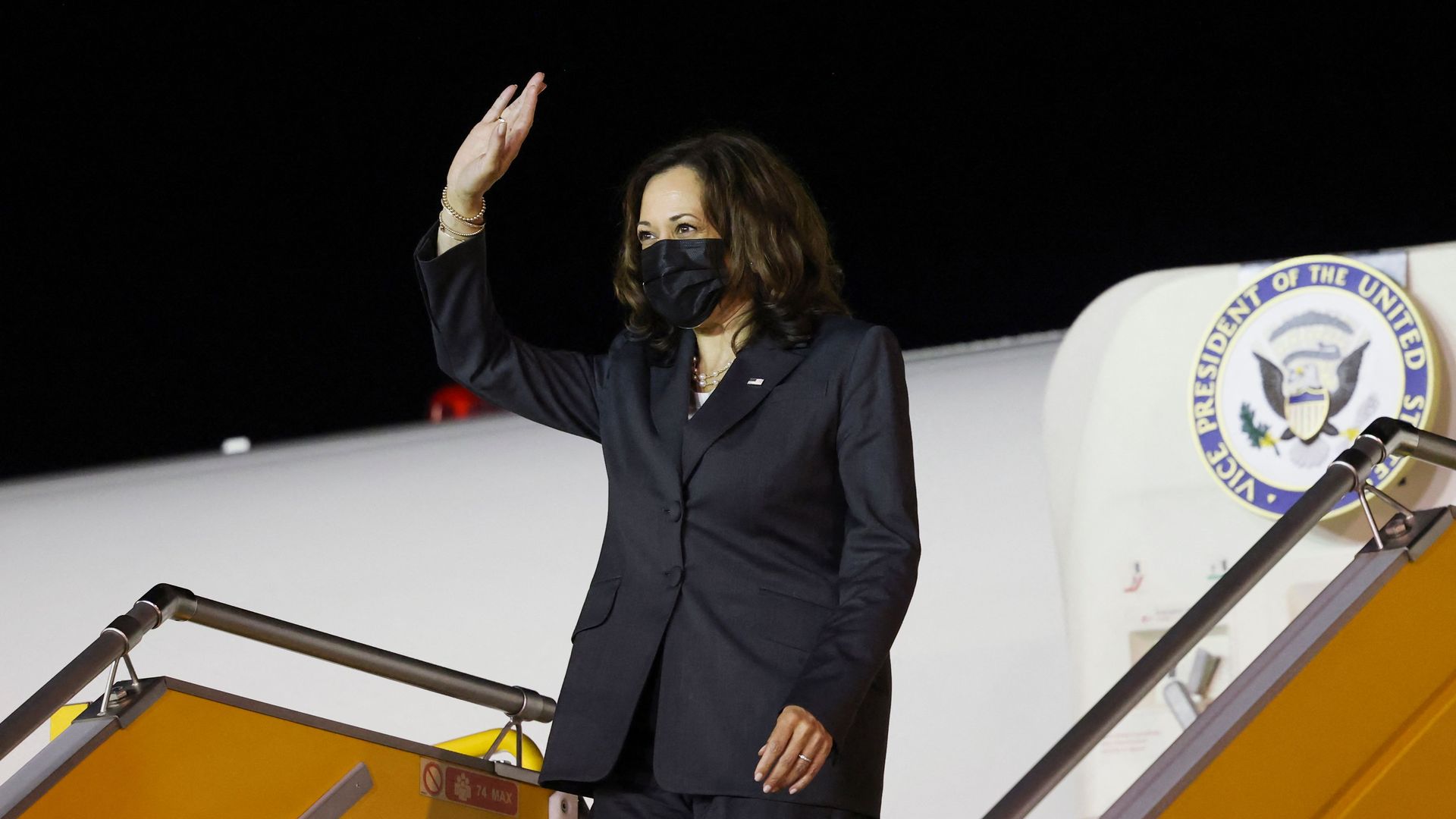 Vice President Kamala Harris waving while exiting her flight
