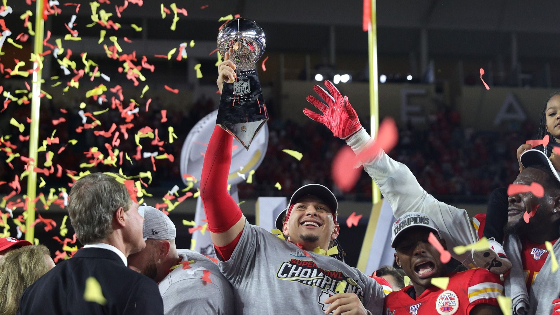 A smiling Patrick Mahomes holds up the Lombardi Trophy with confetti swirling around at the on-field celebration of his first Super Bowl victory in February 2020.