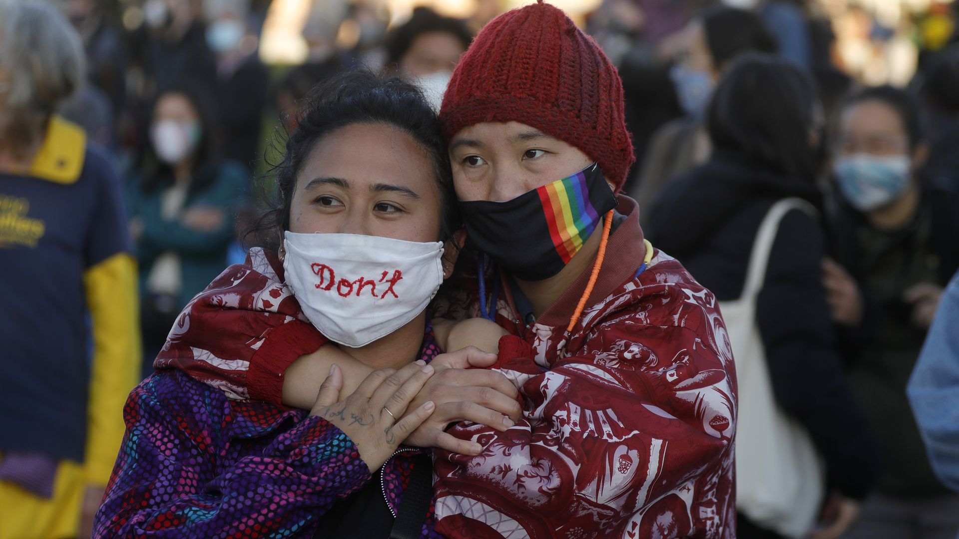 Two women of Asian descent embrace during an anti-Asian hate vigil at Chinatown’s Madison Park in downtown Oakland, Calif.