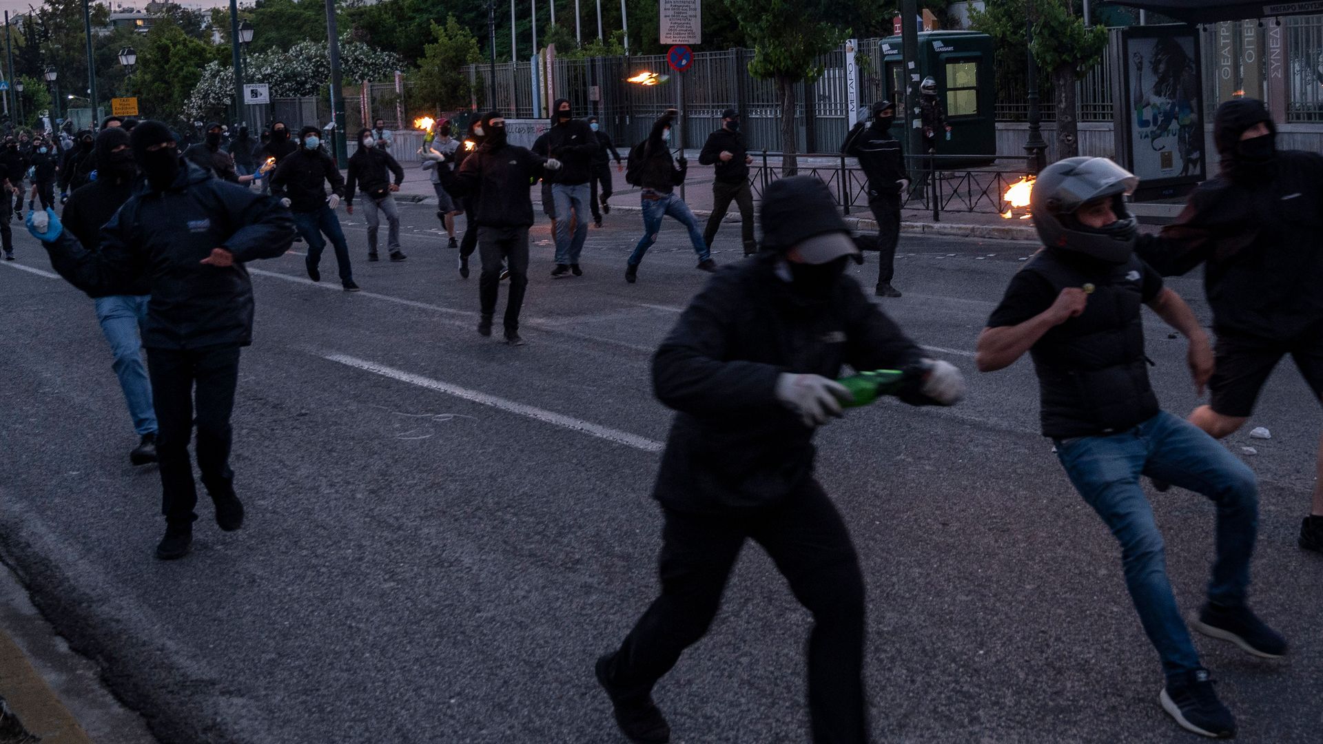 Protesters throw petrol bombs to riot police during a demonstration outside the U.S. embassy in Athens, on June 3