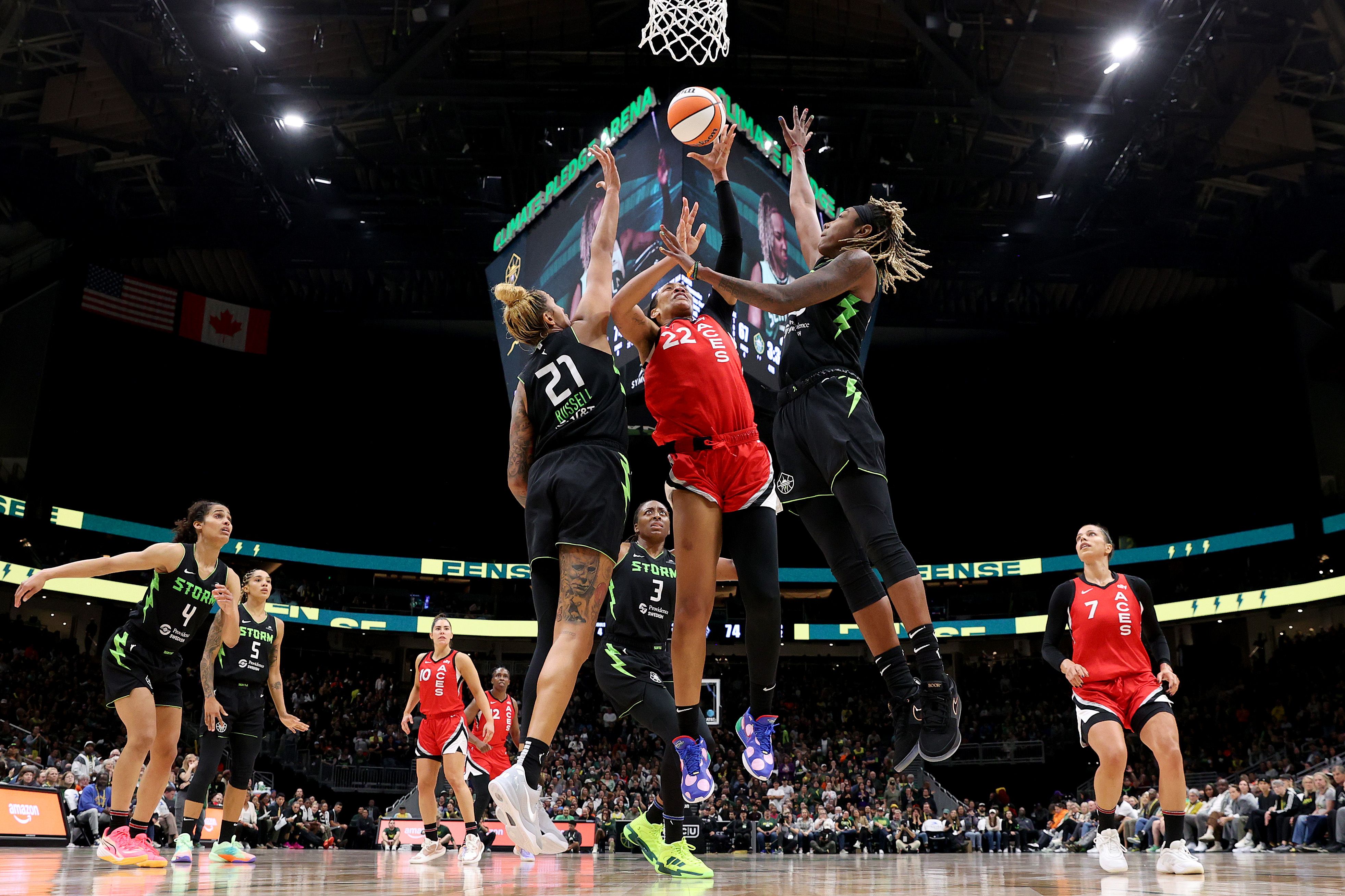 SEATTLE, WASHINGTON - SEPTEMBER 17: A'ja Wilson #22 of the Las Vegas Aces shoots against Mercedes Russell #21 and Jordan Horston #23 of the Seattle Storm at Climate Pledge Arena on September 17, 2024 in Seattle, Washington. NOTE TO USER: User expressly acknowledges and agrees that, by downloading an
