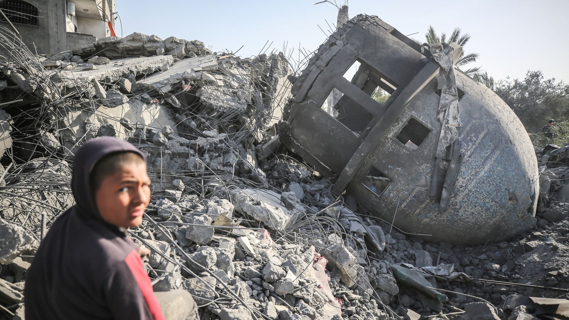 A Palestinian child in the rubble of a mosque in central Gaza.