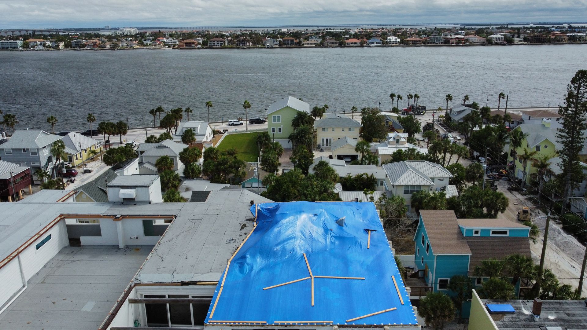 A drone image of a tarp covered apartment complex in the Pass-A-Grille section of St. Petersburg ahead of Hurricane Milton's expected landfall in the middle of this week on October 7, 2024 in Florida. Florida's governor has declared a state of emergency on Saturday as forecasters warned that Hurrica