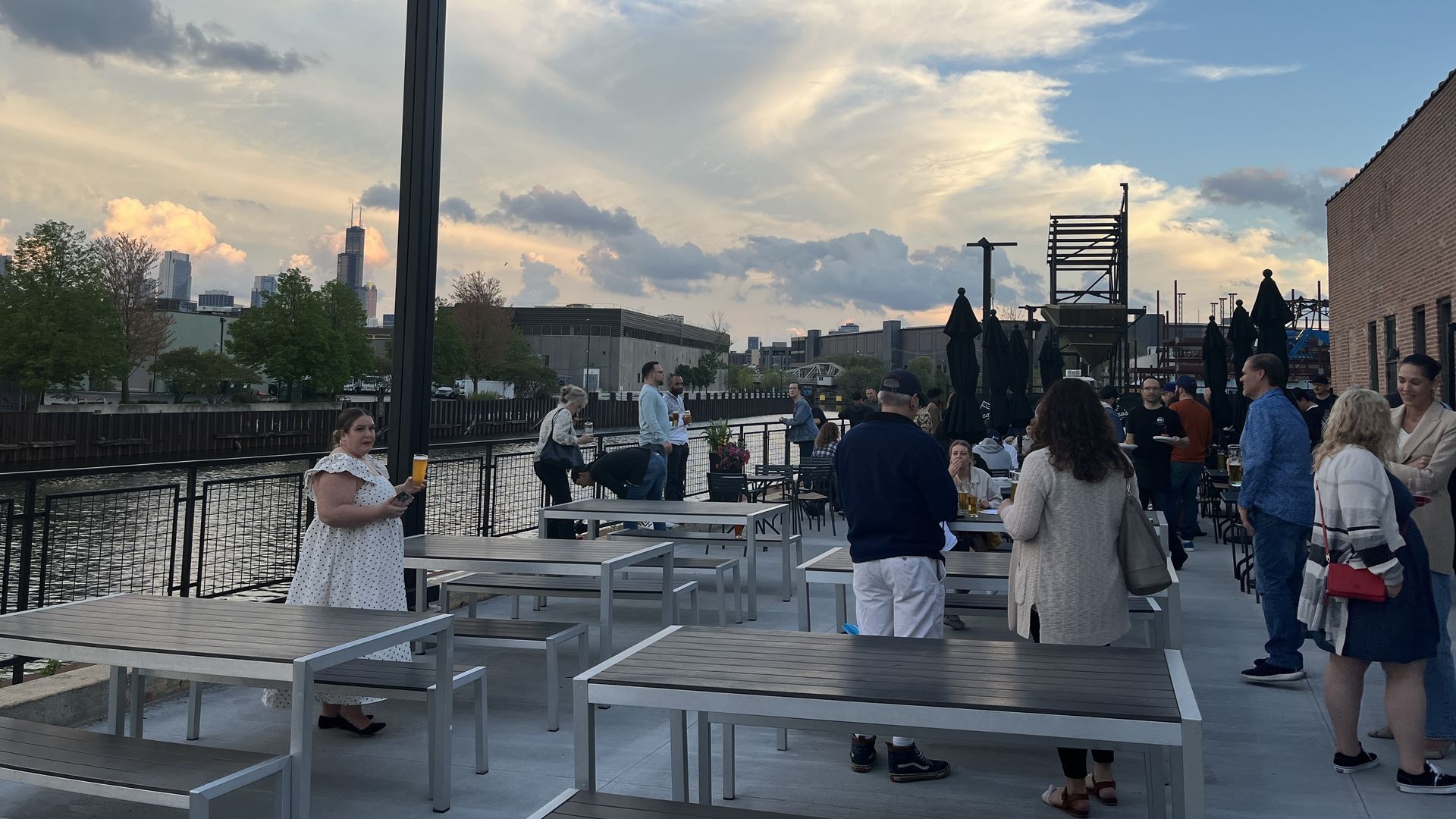 Photo of people on a deck near a river 