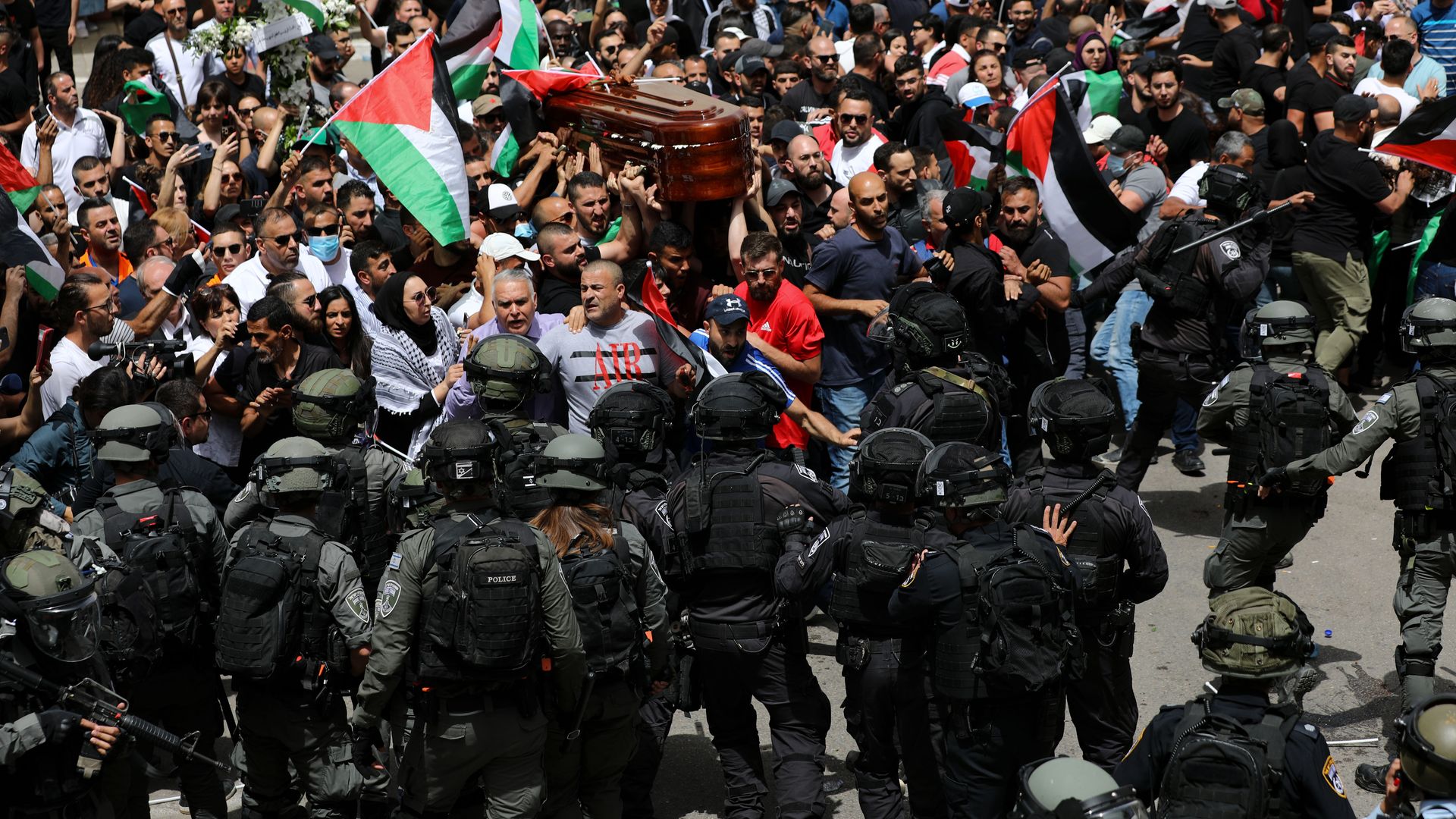 Israeli police beat mourners carrying Shireen Abu Akleh's casket outside a hospital in Jerusalem.