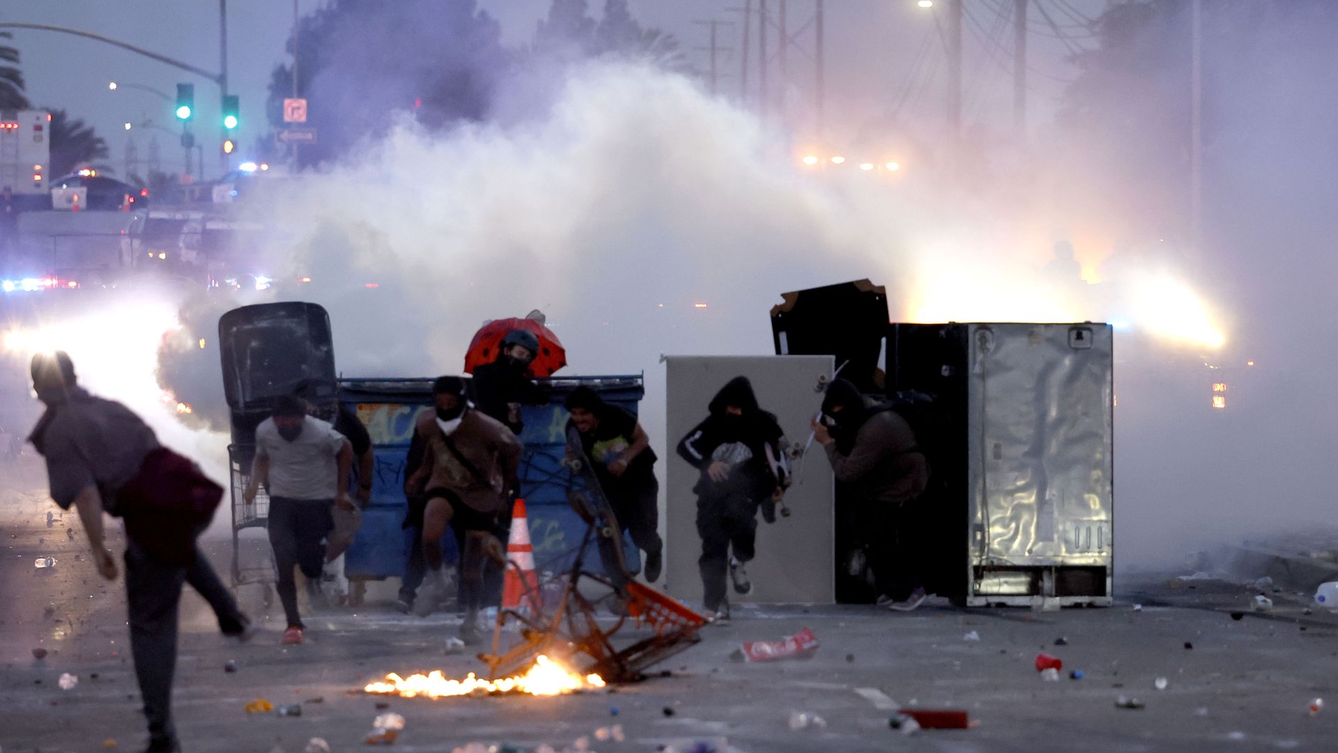 Protesters run away from a crowd of smoke during a demonstration in Compton.