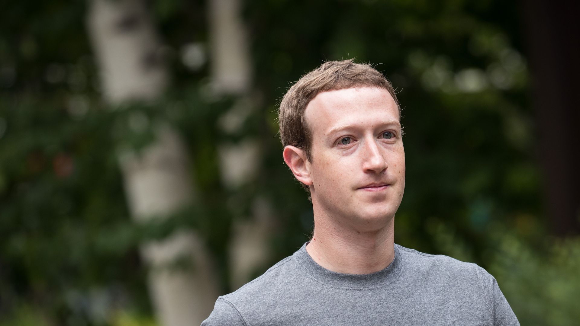 Mark Zuckerberg walks in front of trees