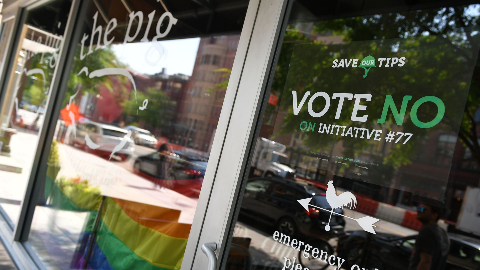 A restaurant door displays a poster opposing Initiative 77 from 2018