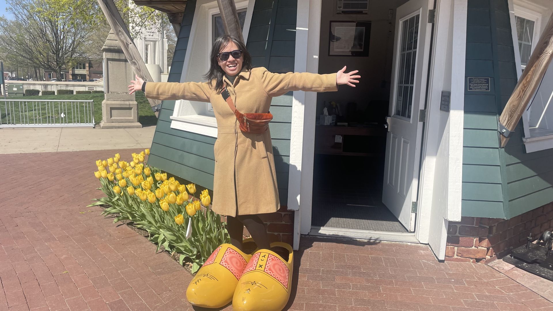 Linh in front of a windmill in giant clogs