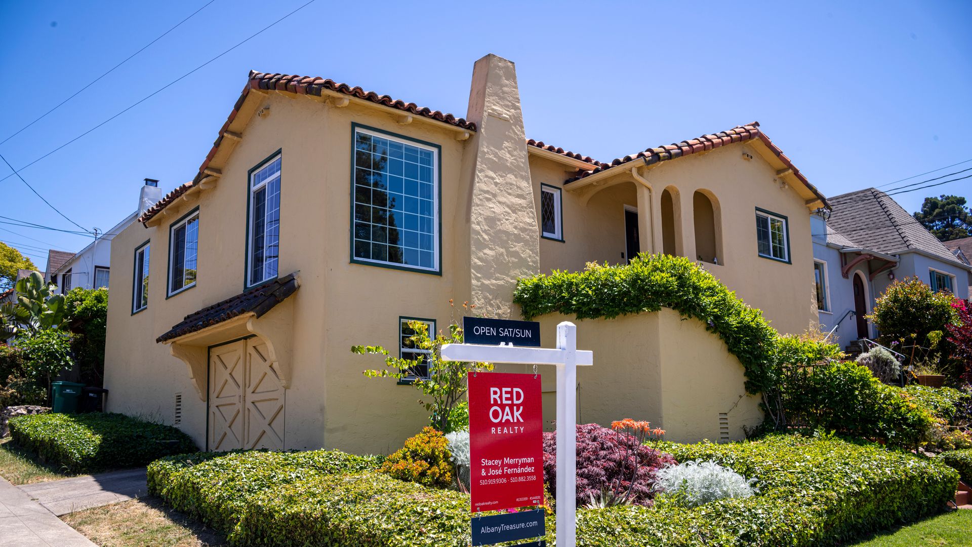 A "For Sale" sign outside a house in California.