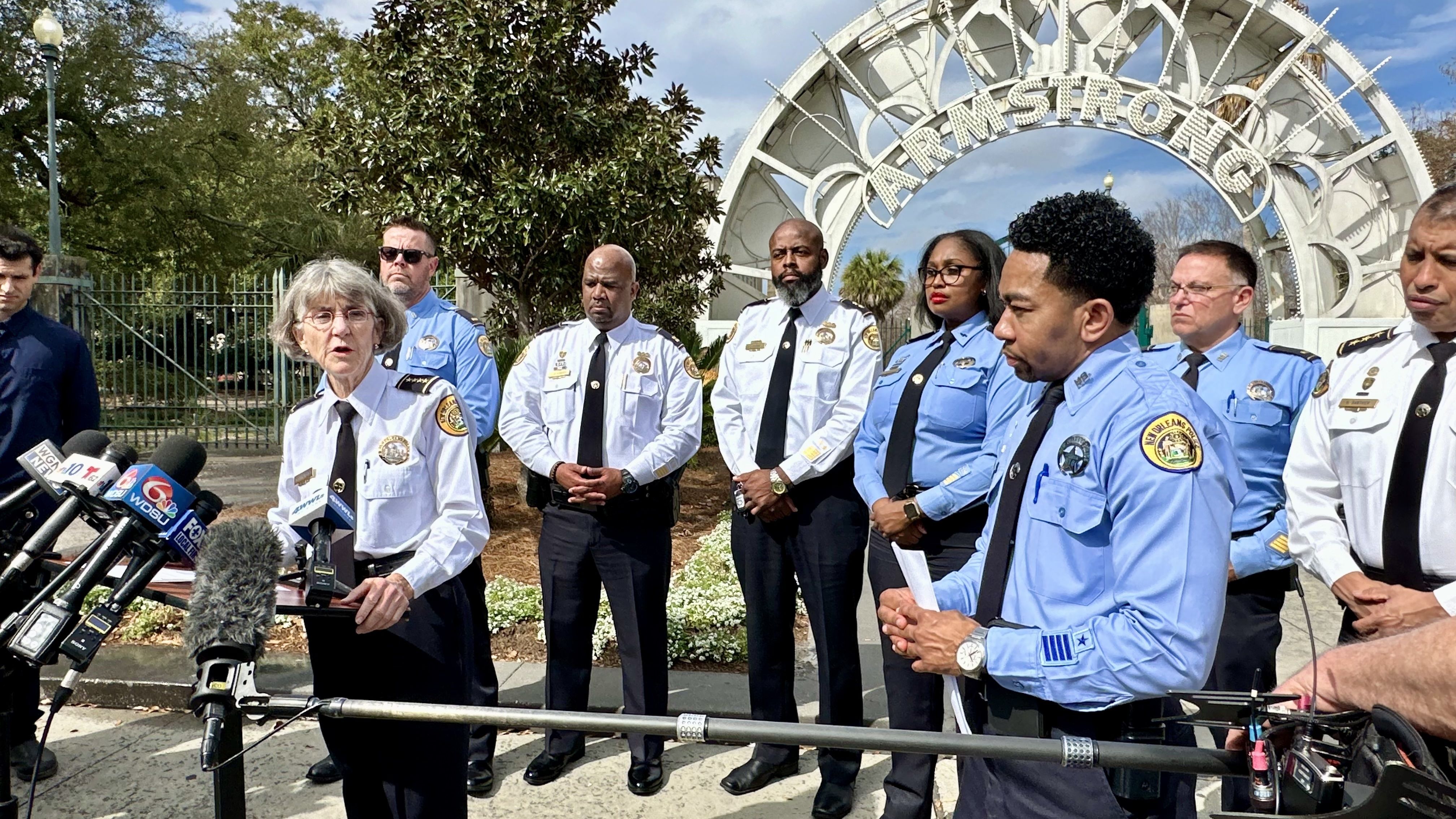 Photo shows Chief Anne Kirkpatrick and her top brass in front of the Armstrong Park sign.