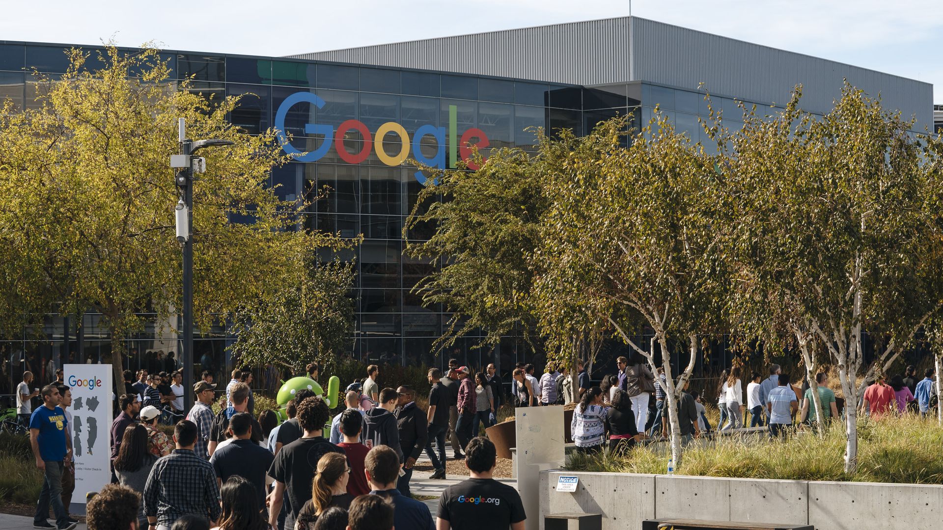 Photo of employees walking out of Google headquarters. 