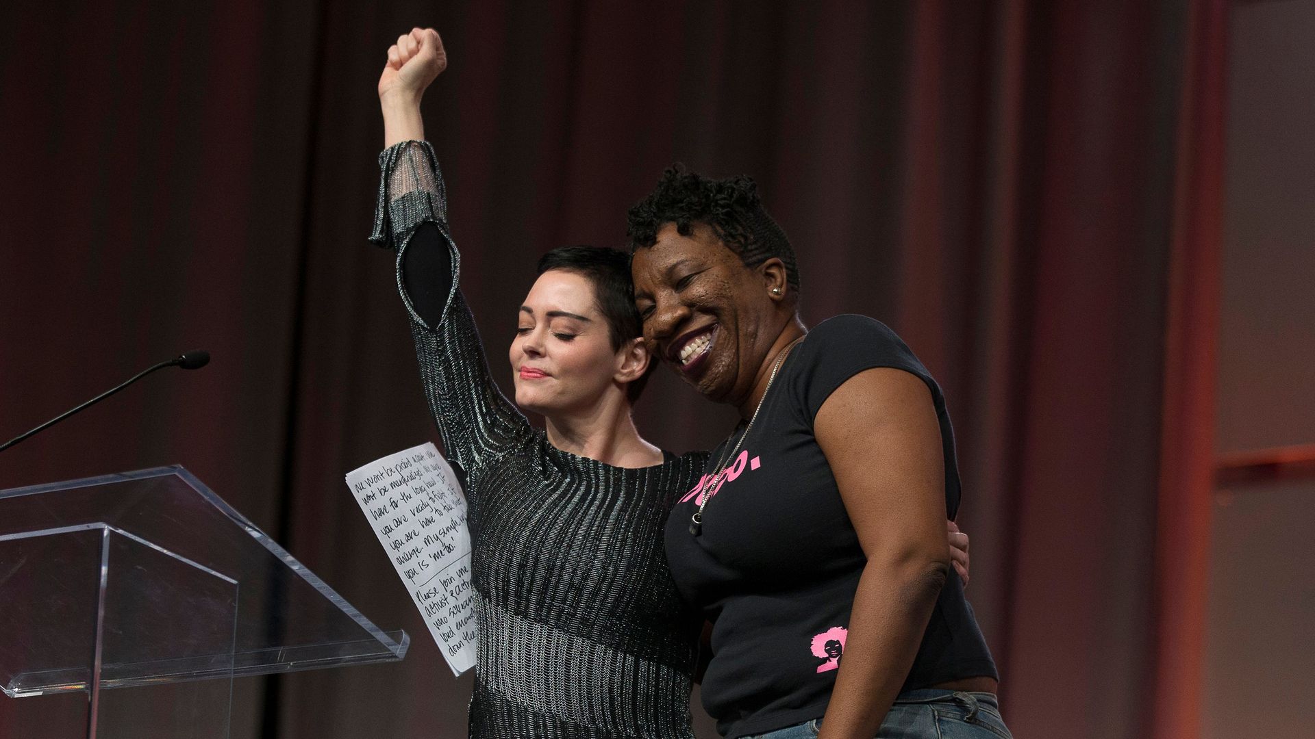 Actor Rose McGowan and Founder of #MeToo Campaign Tarana Burke, embrace on stage at the Women's March / Women's Convention in Detroit, Michigan, on October 27