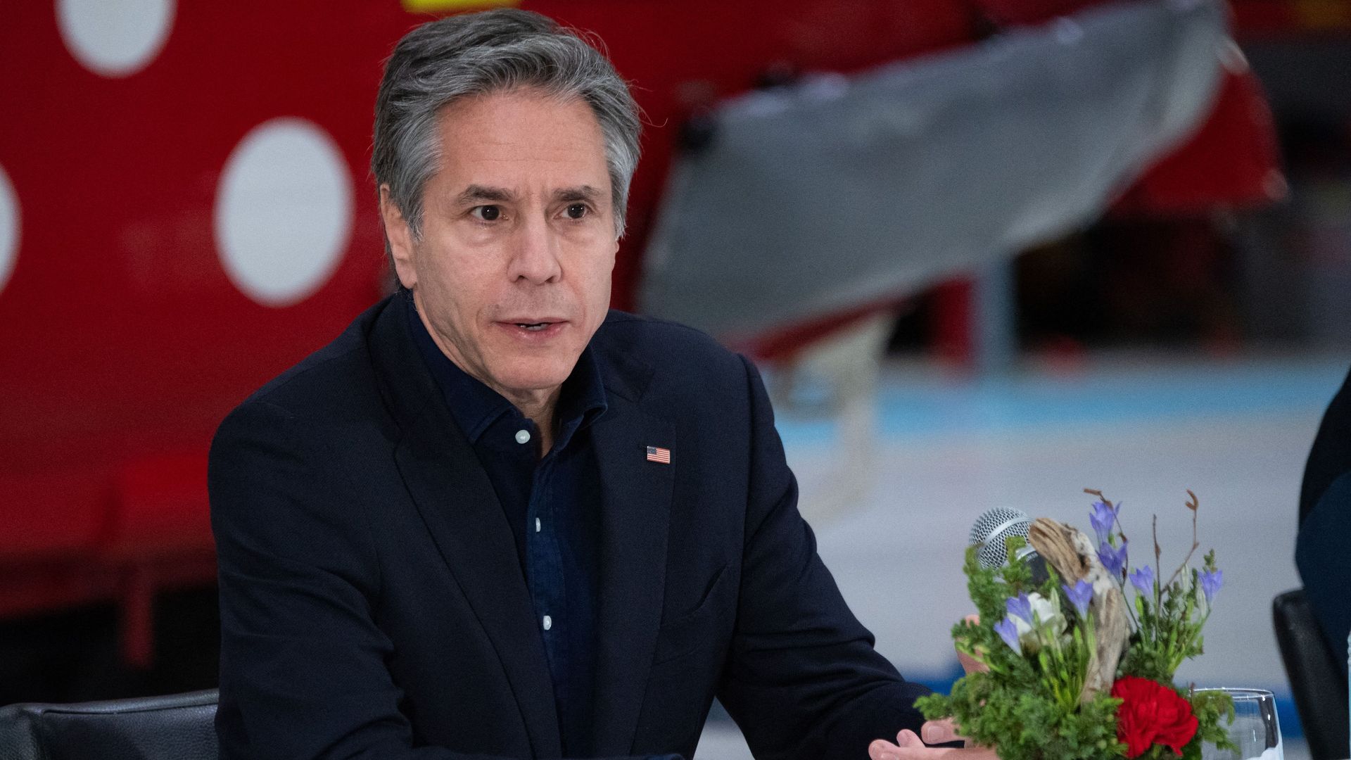 Antony Blinken sits at a table