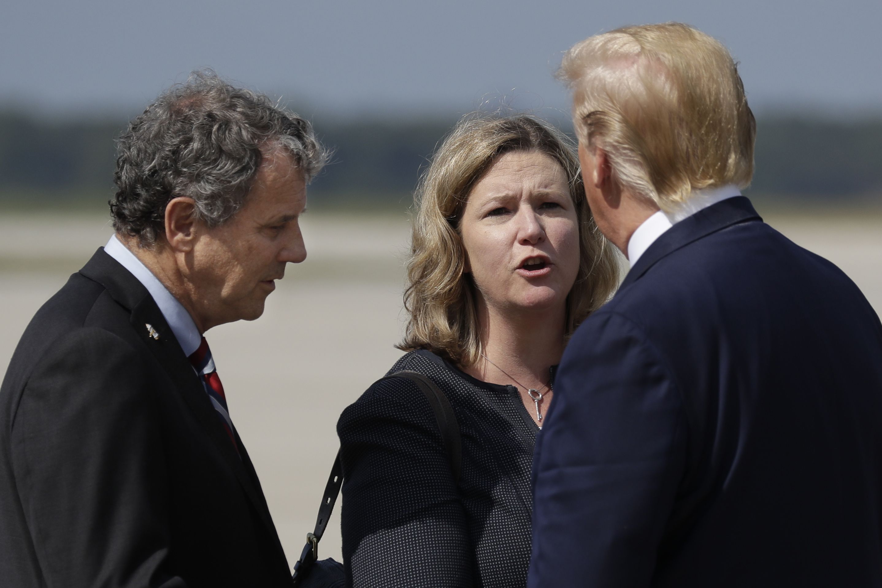 Trump is greeted by Dayton Mayor Nan Whaley and Sen. Sherrod Brown, D-Ohio