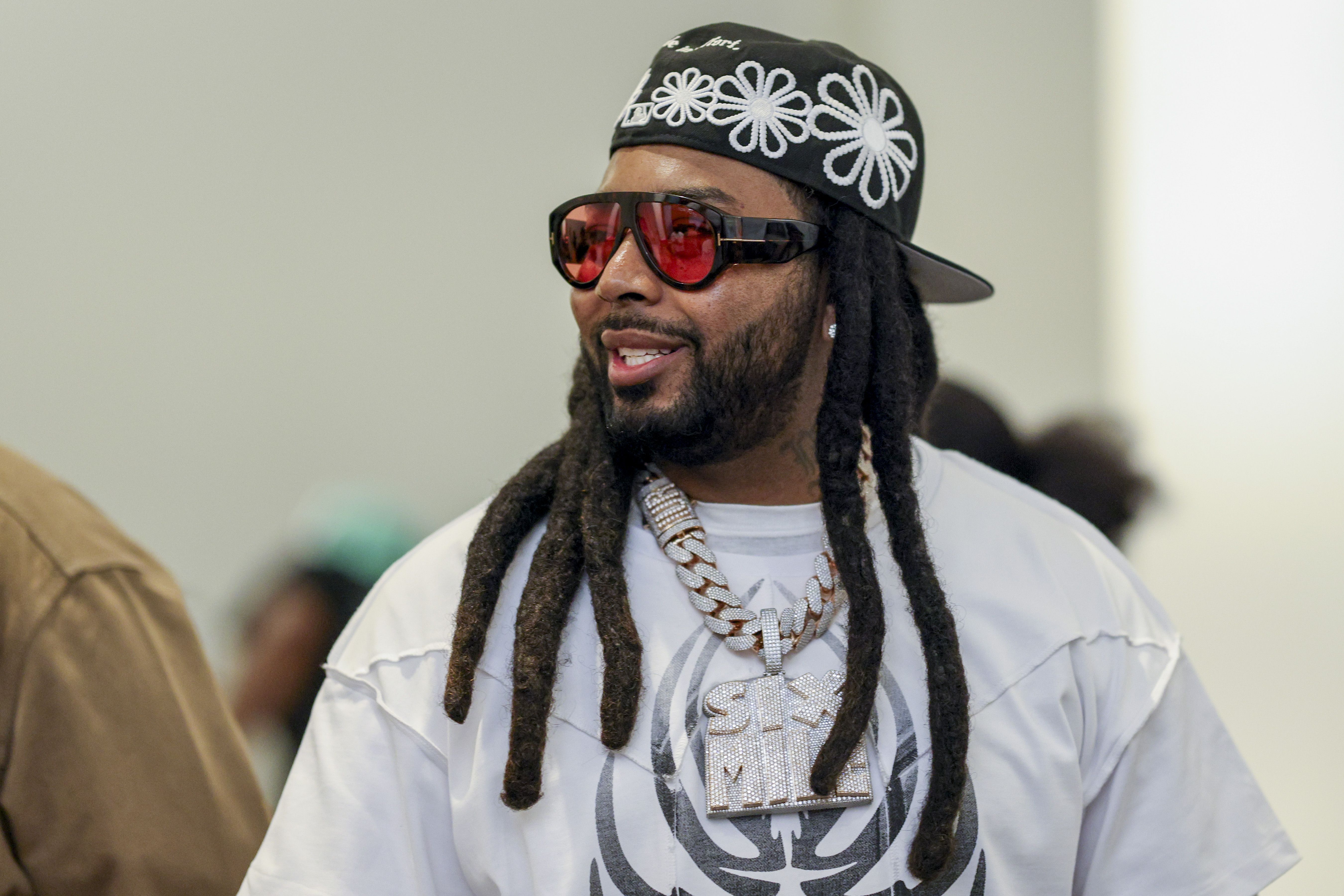 Icewear Vezzo looks right, wearing a hat and sunglasses