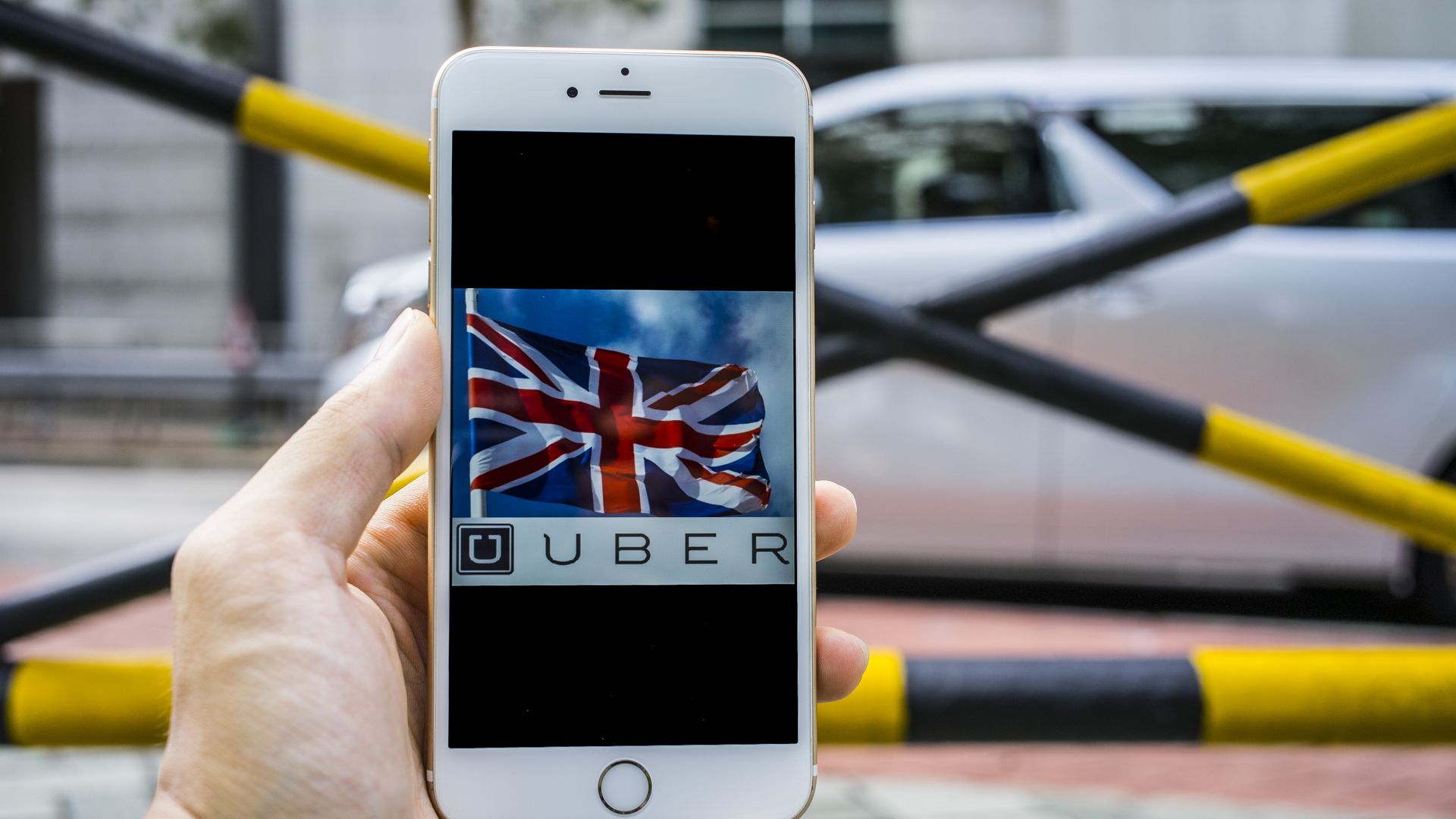 An iPhone with the Union flag and Uber logo on it.