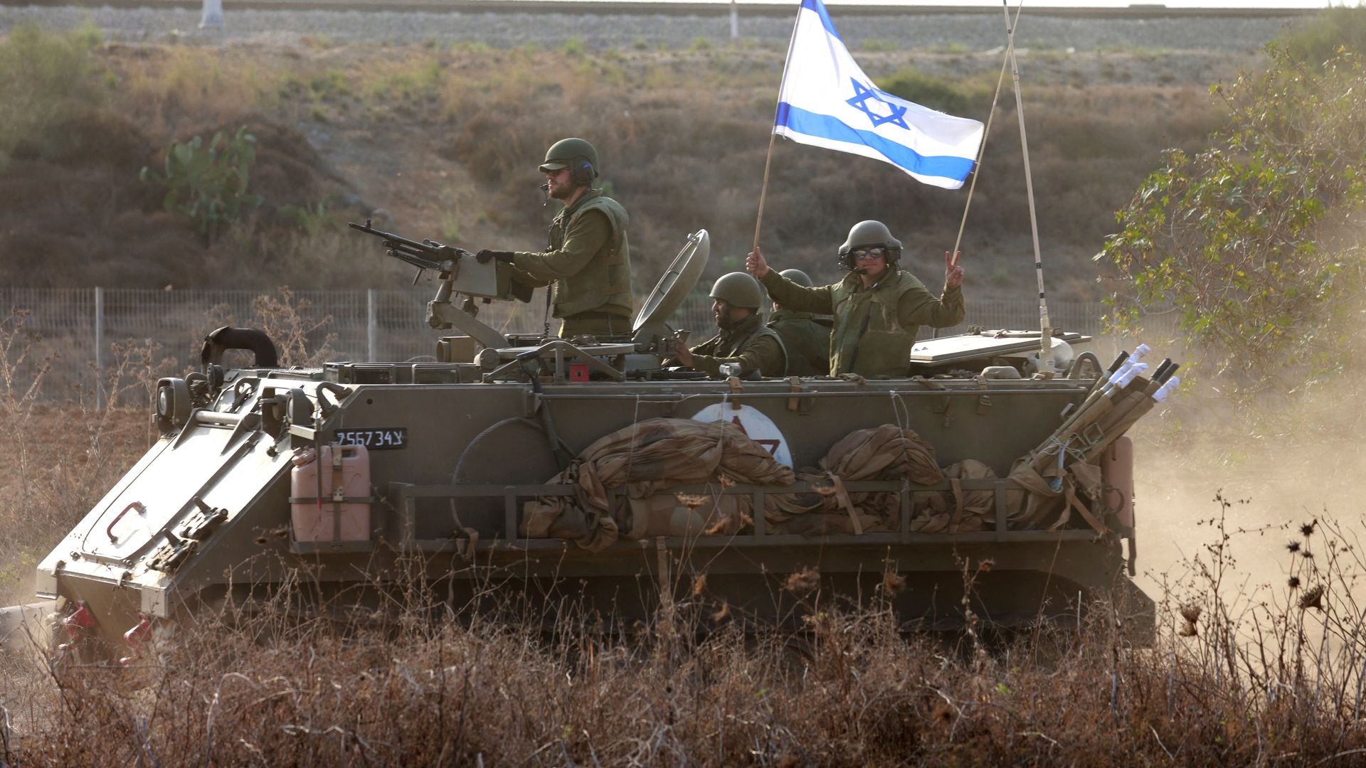 Israeli forces arrive on an armoured personnel carrier (APC) as additional troops are deployed near the southern city of Sderot on October 8, 2023. 