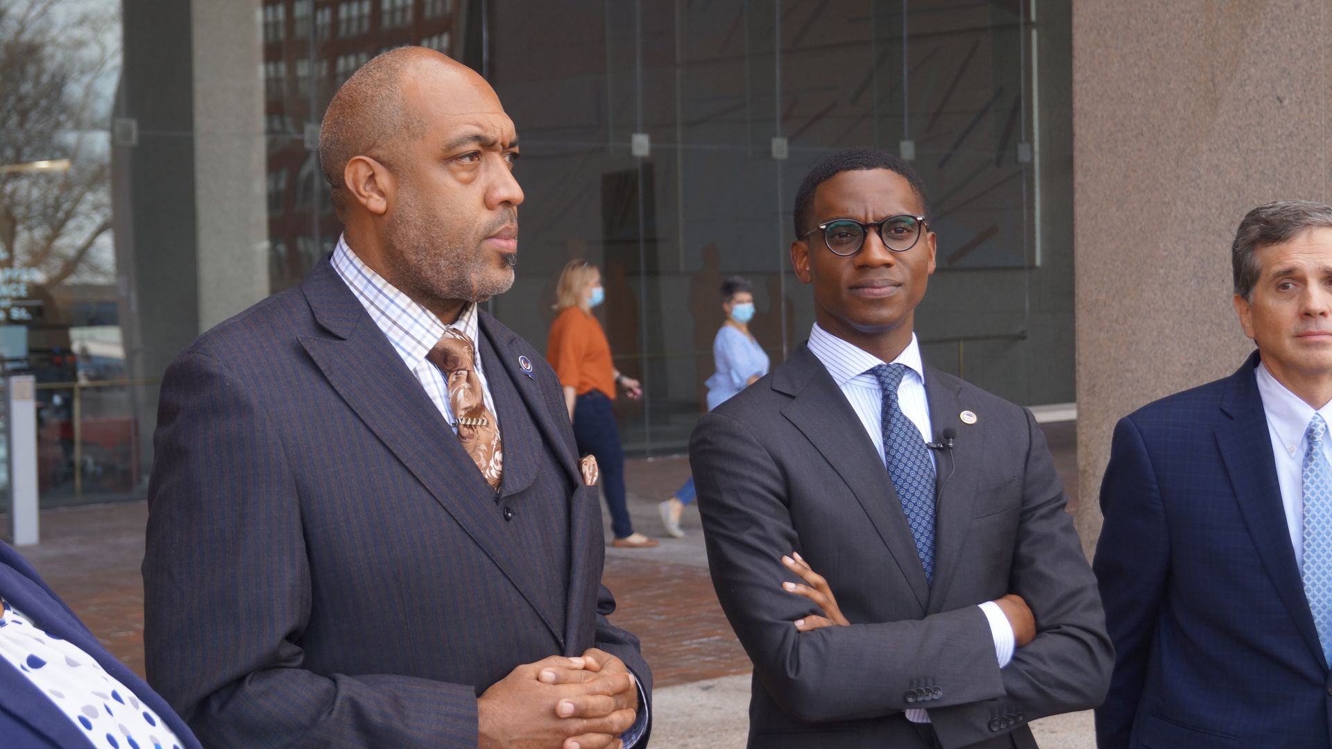 Two black men in suits, one in glasses