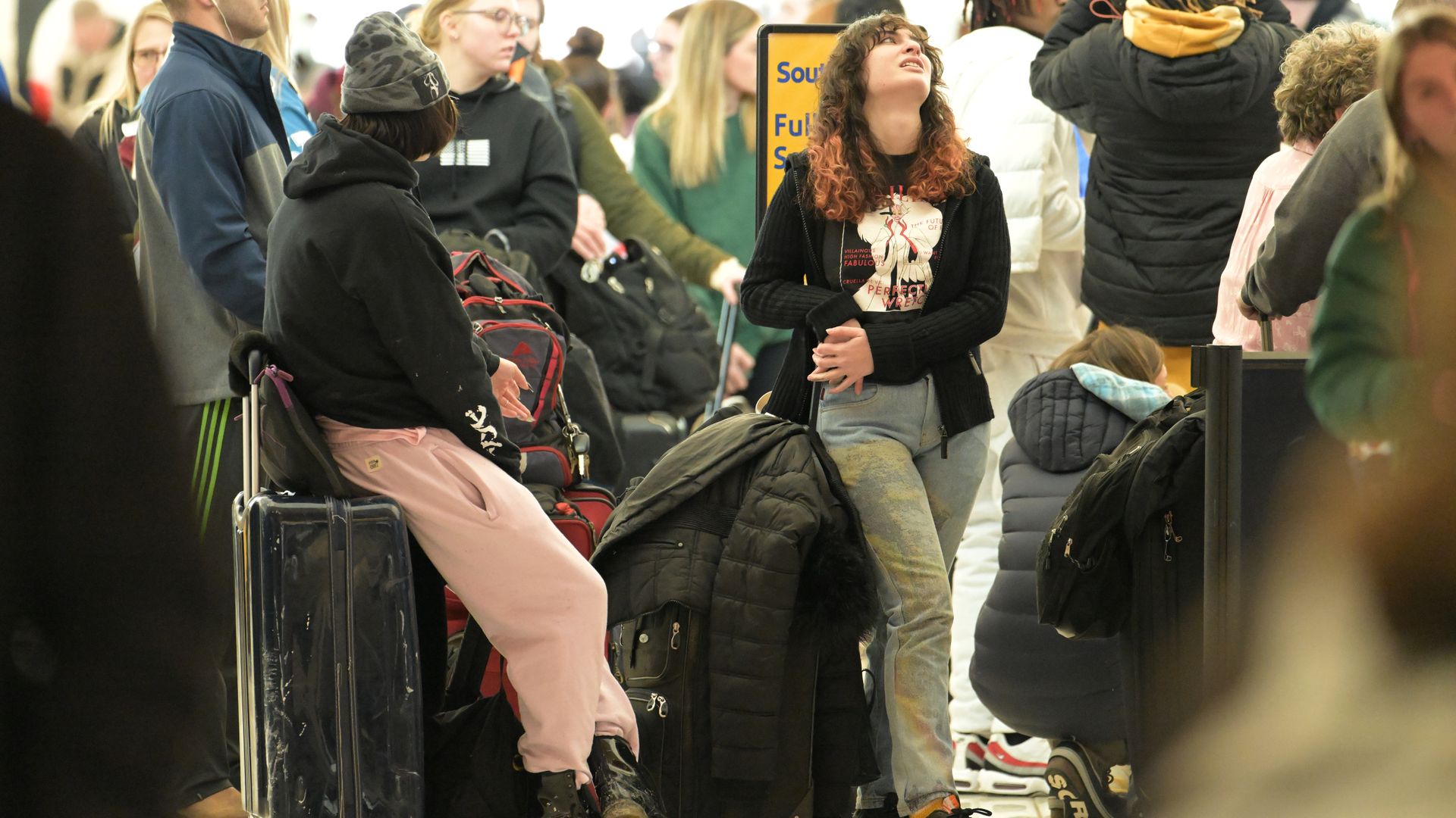 Ella Silverstein lookup air during her waiting in the line to book flight in front of Southwest Airlines ticket counter at Denver International Airport in Denver, Colorado on Thursday, December 22.