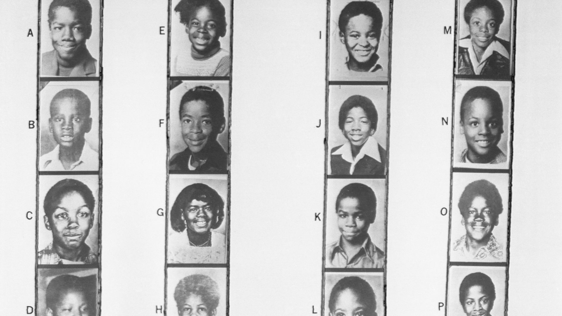 Rows of photographs of young Black children who were some of the victims in the Missing and Murdered Children cases in Atlanta