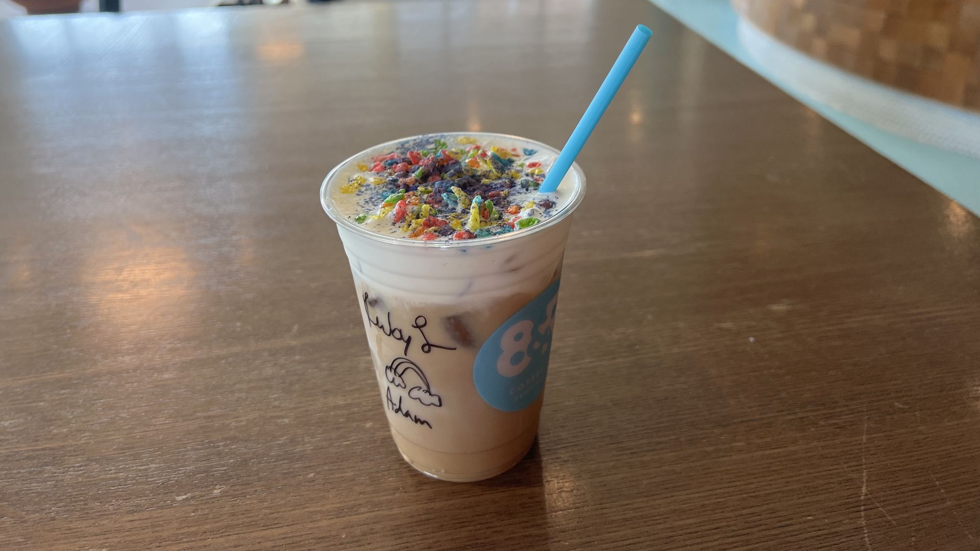 A latte covered with Fruity Pebbles cereal.